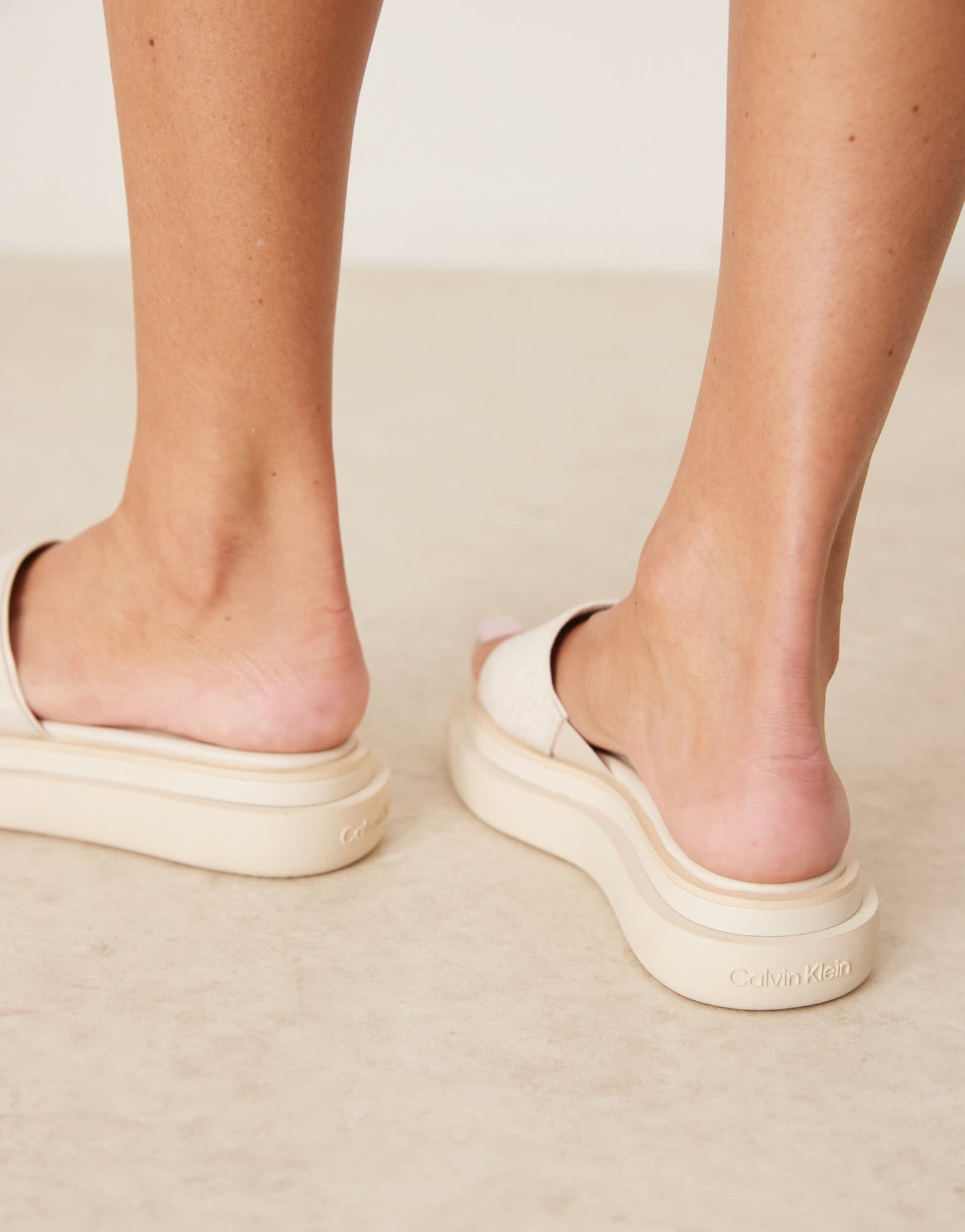 Calvin Klein flatform sliders in off white