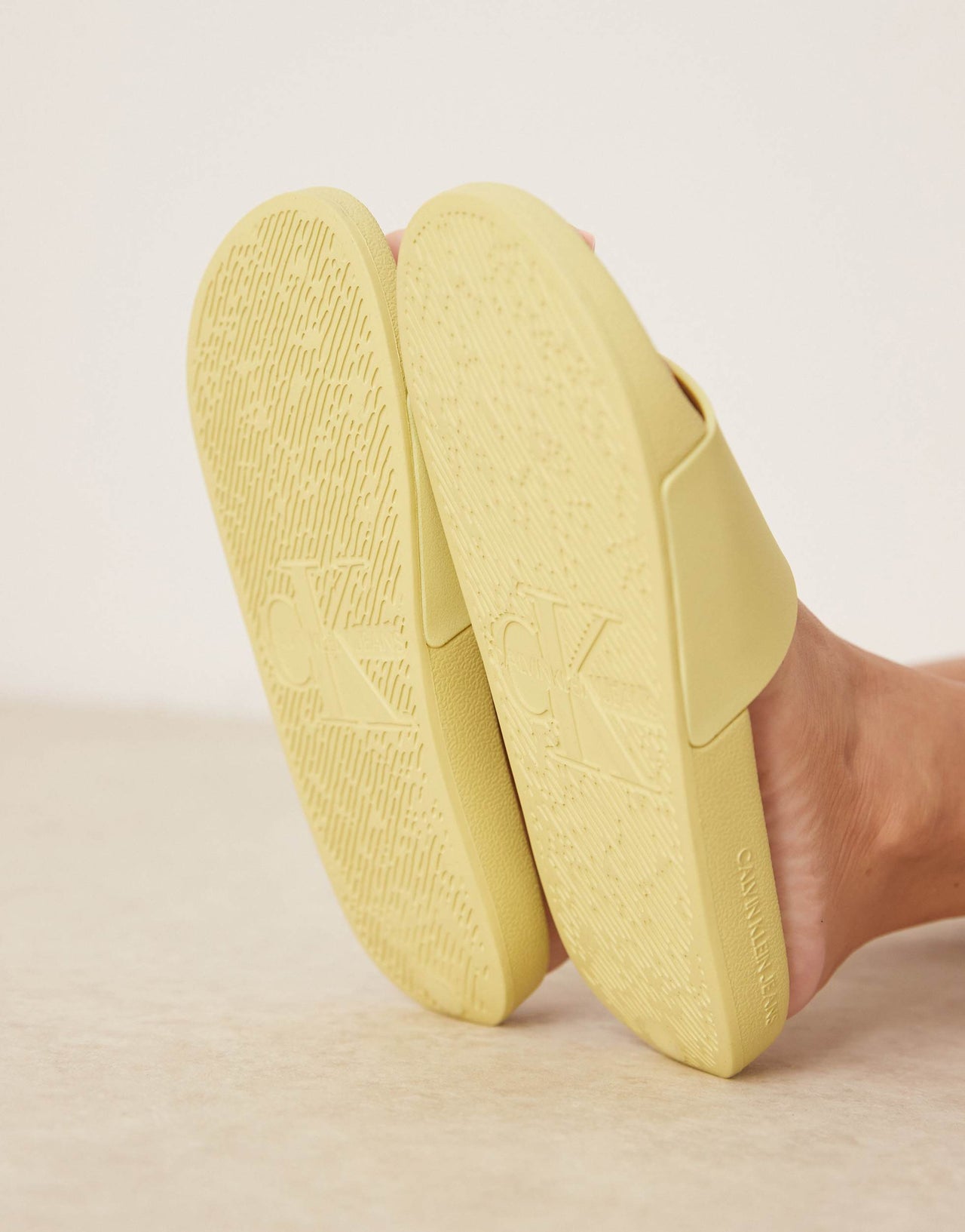 Calvin Klein monogram sliders in yellow