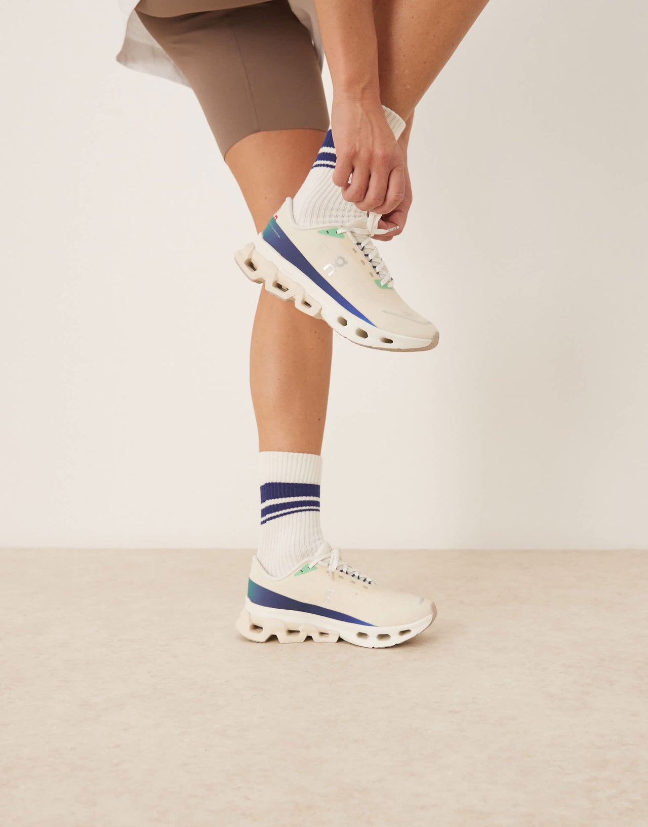 ON Cloudspark running trainers in cream and blue