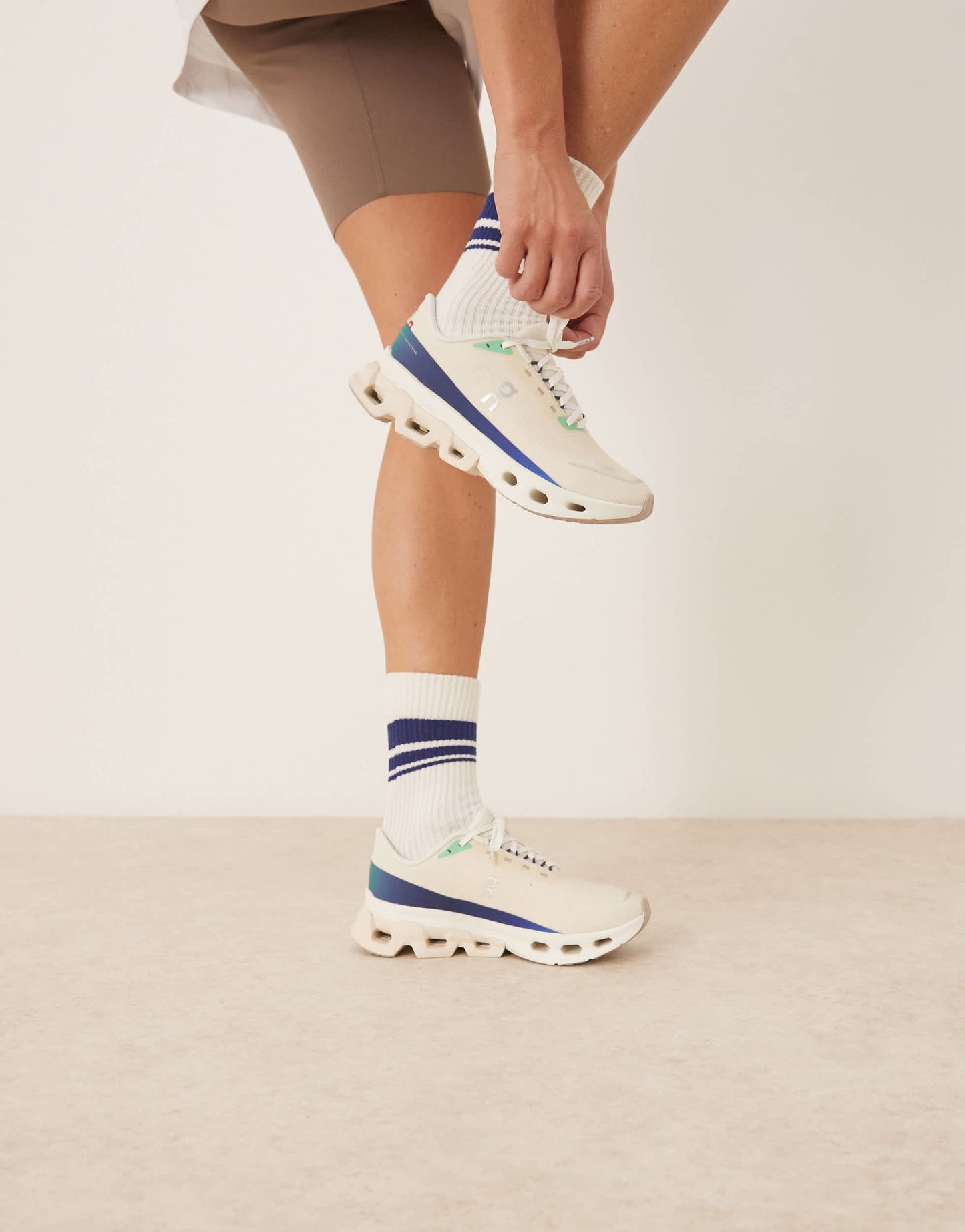 ON Cloudspark running trainers in cream and blue