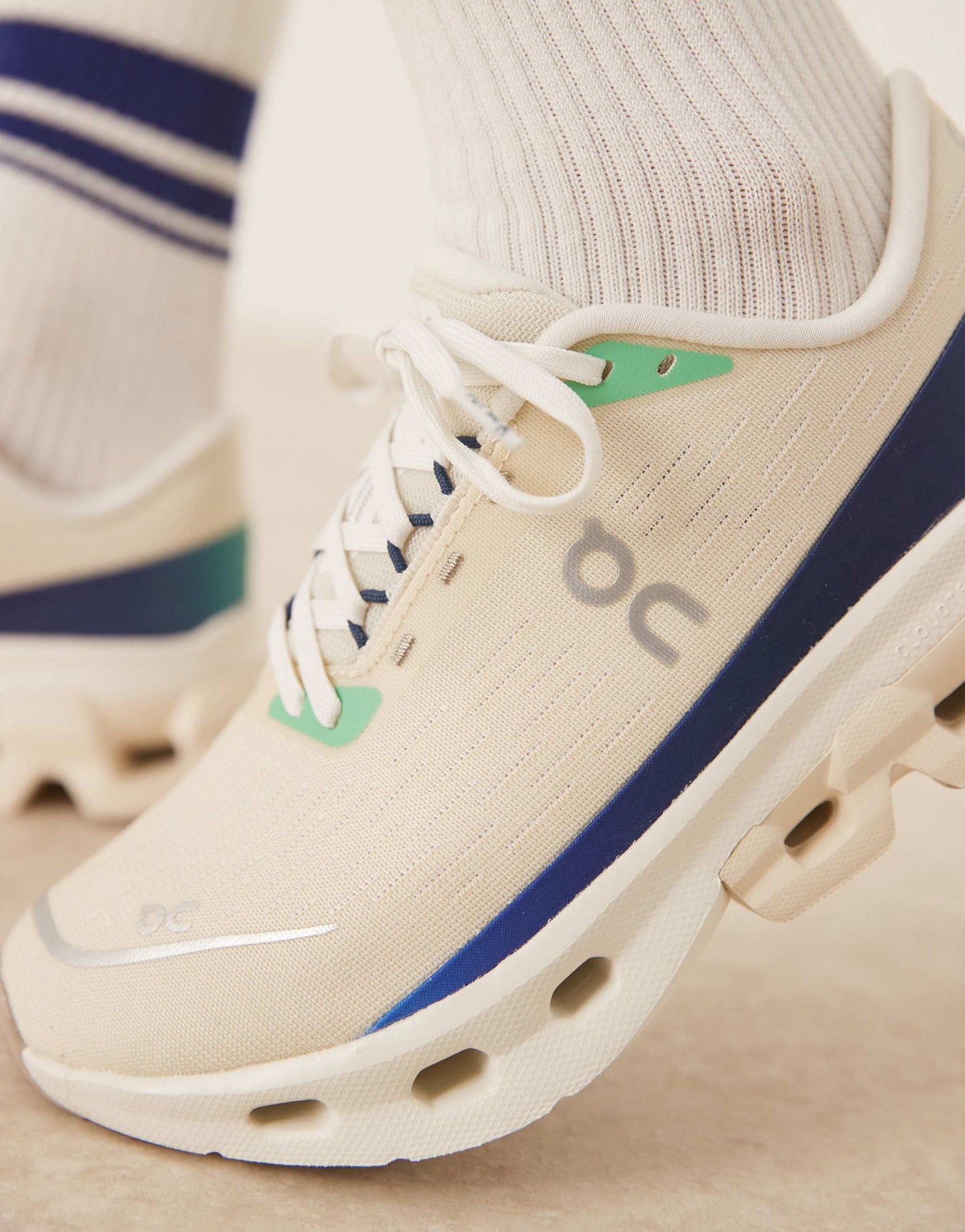ON Cloudspark running trainers in cream and blue