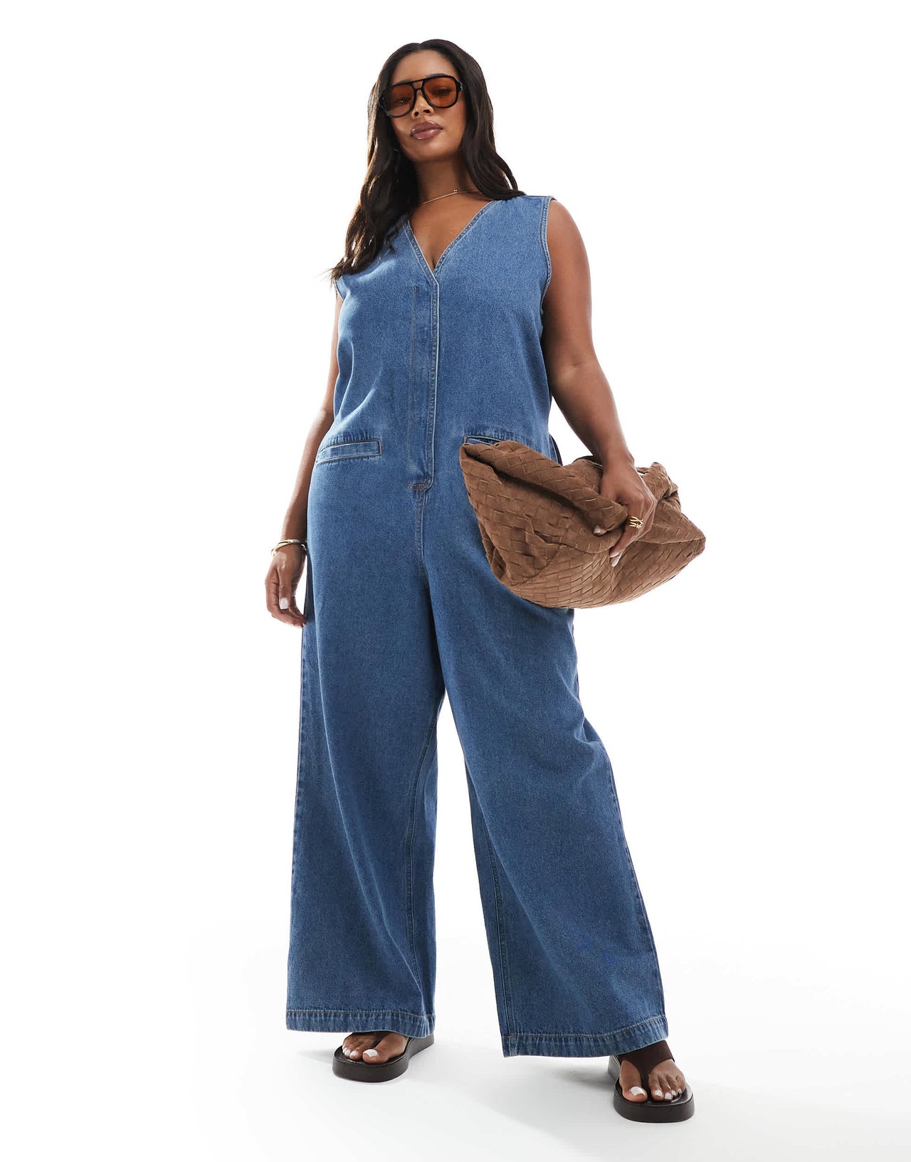 ASOS DESIGN Curve denim sleeveless loose jumpsuit in midwash blue