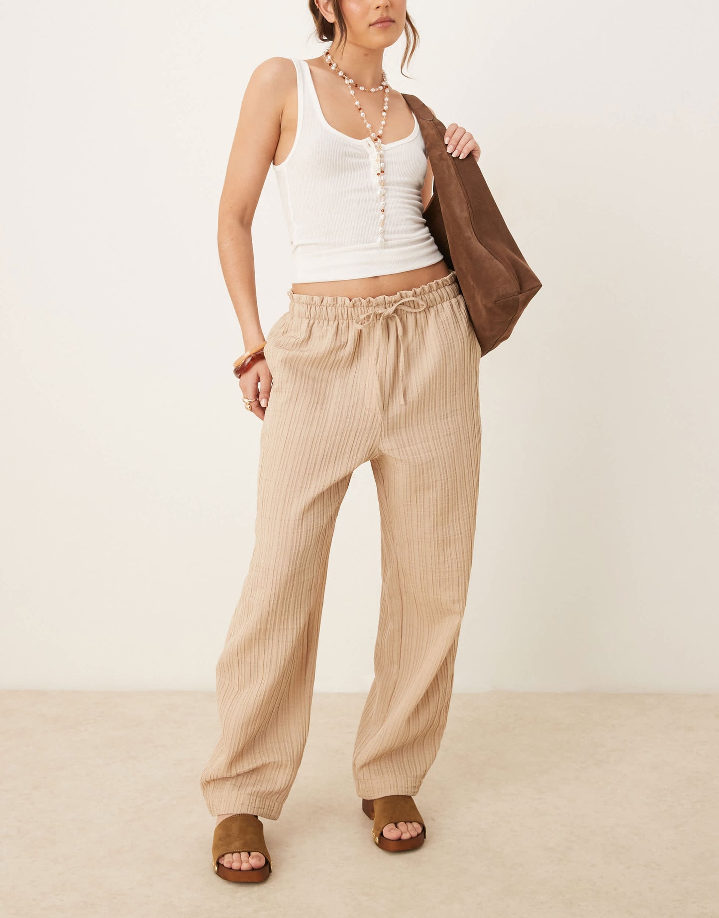 ASOS DESIGN tailored textured drawstring waist arch leg trousers in stone