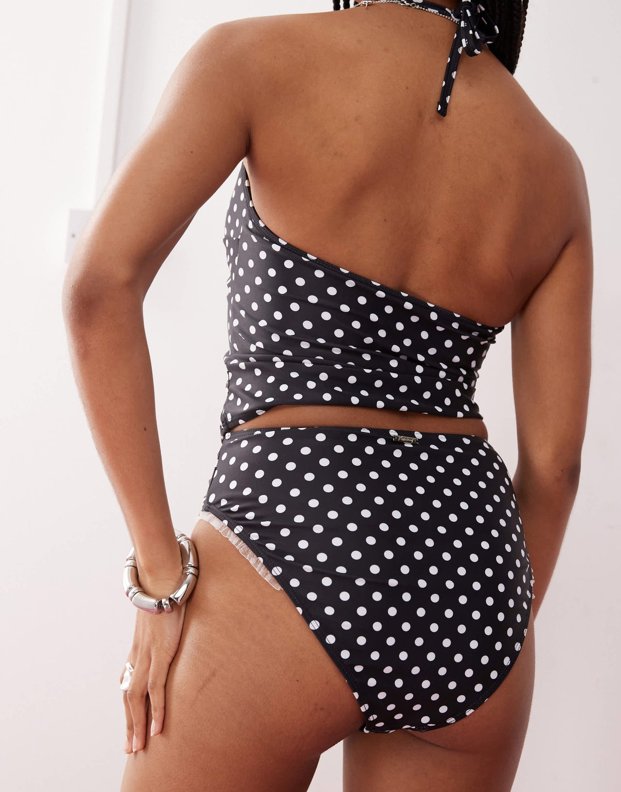Reclaimed Vintage high waist bikini bottom with frilly trim in black polka dot print