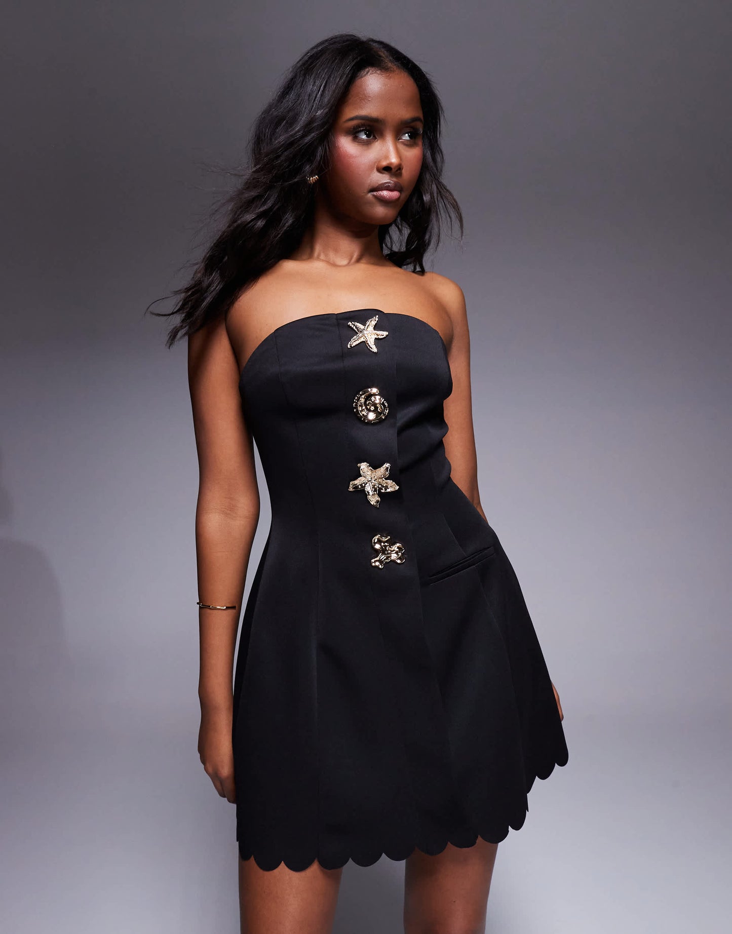 ASOS DESIGN scallop edge  bandeau mini dress with gold shell buttons in black in scuba-style fabric