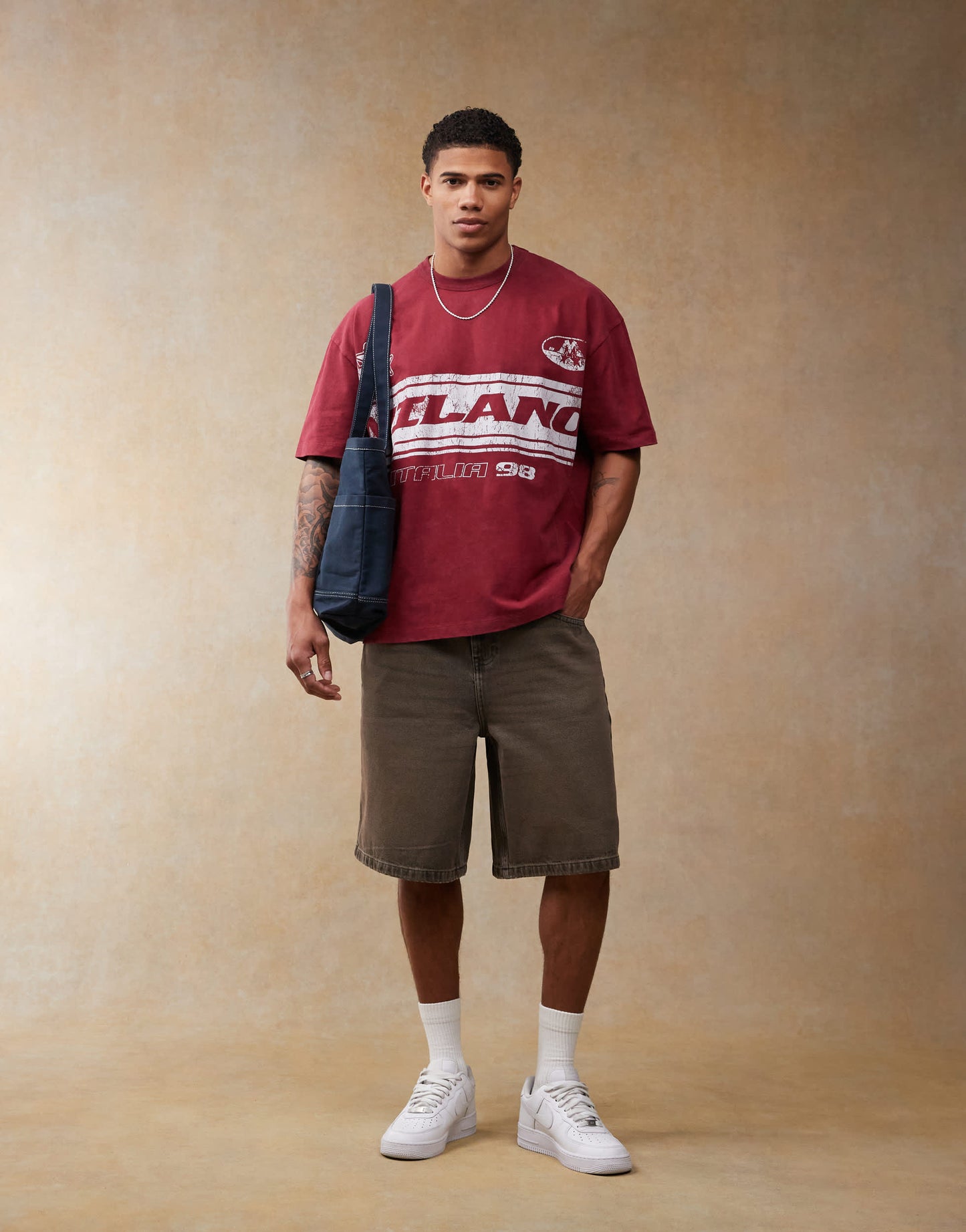 ASOS DESIGN oversized t-shirt with football chest print in burgundy