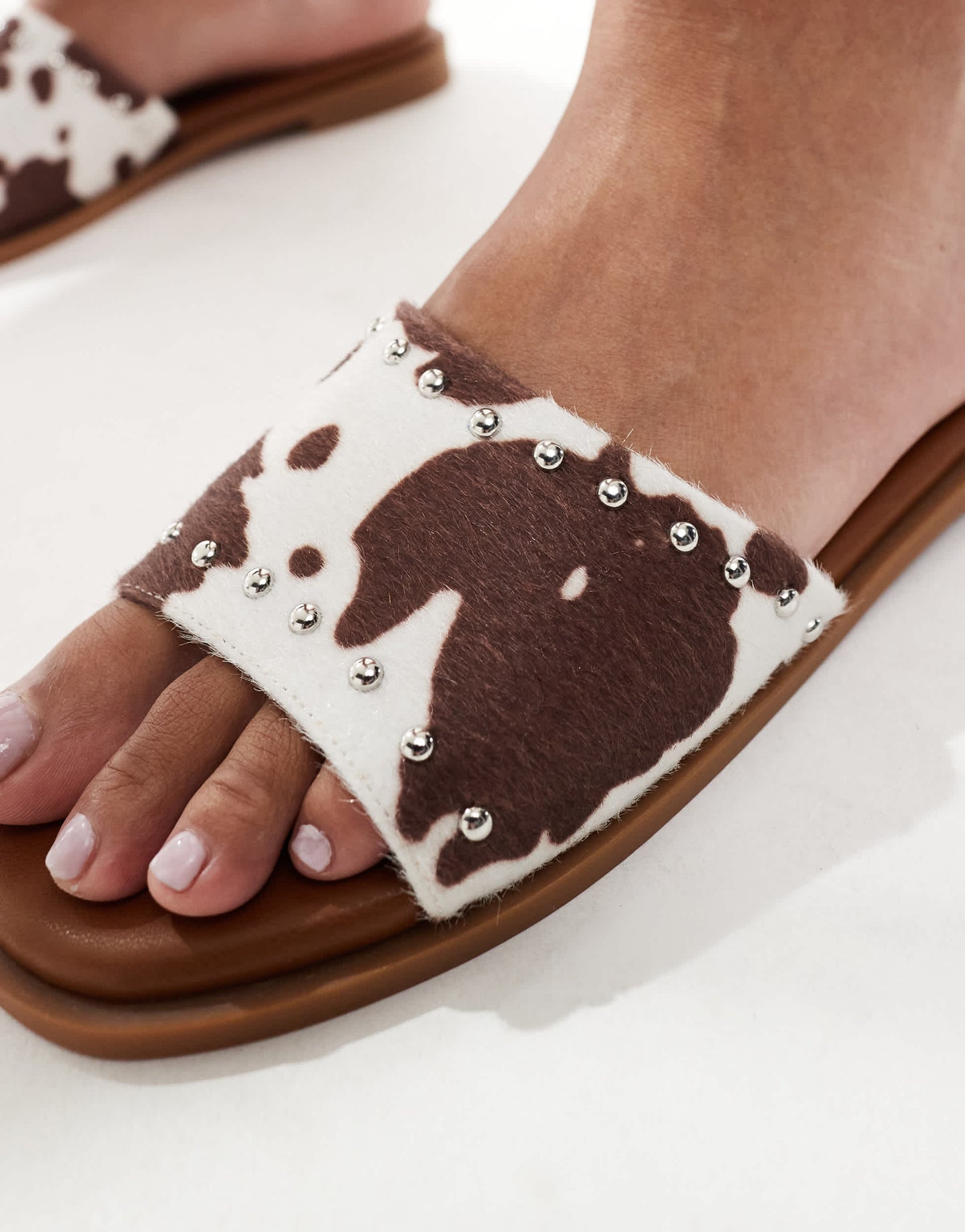 London Rebel flat sandal with studded strap in cow print