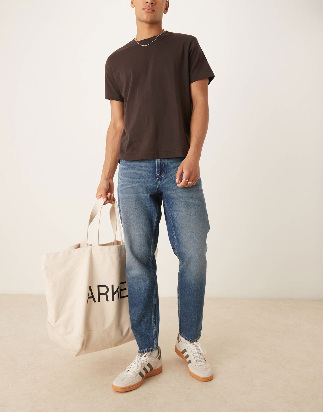 ASOS DESIGN tapered fit jeans with vintage tint in light wash blue