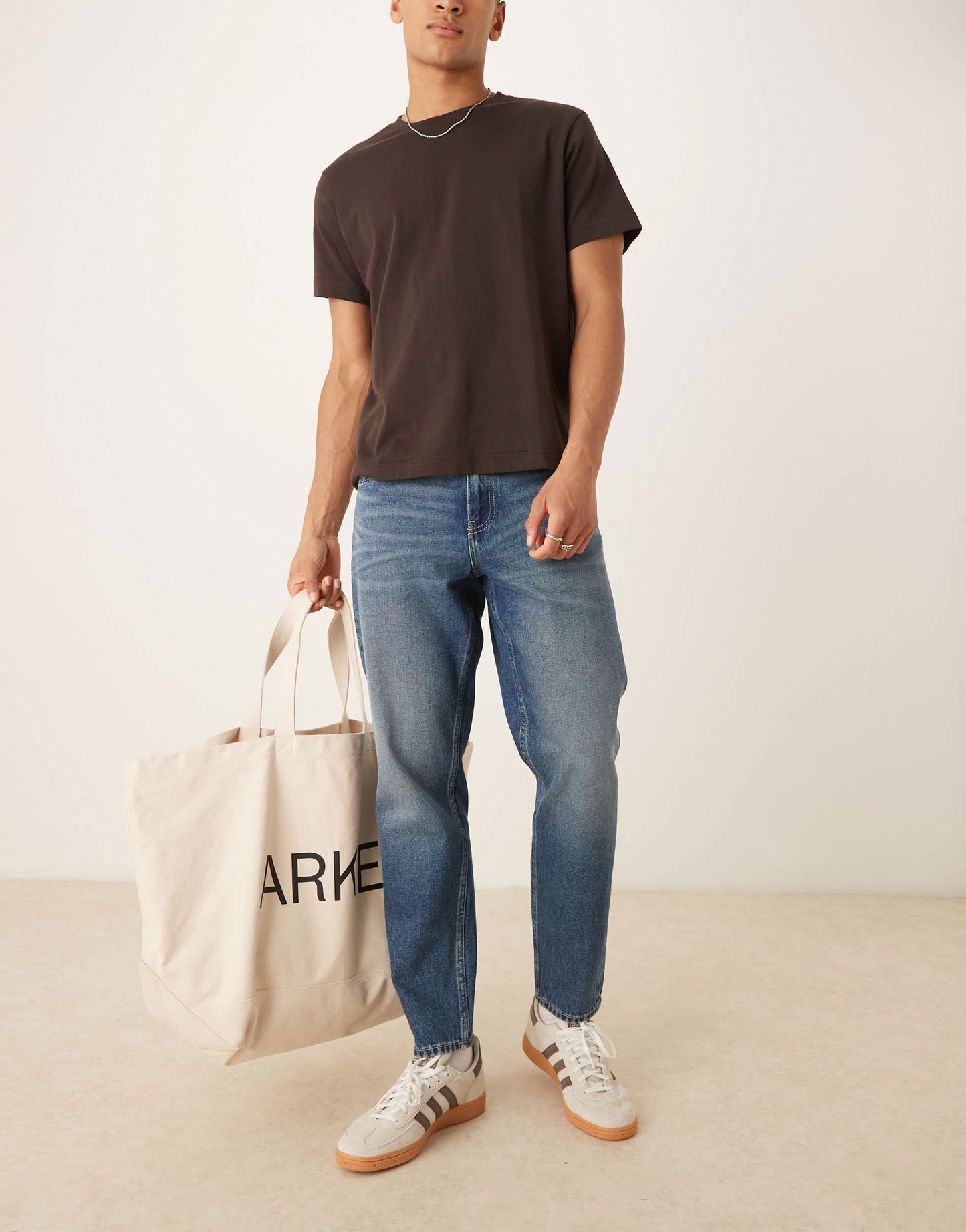 ASOS DESIGN tapered fit jeans with vintage tint in light wash blue