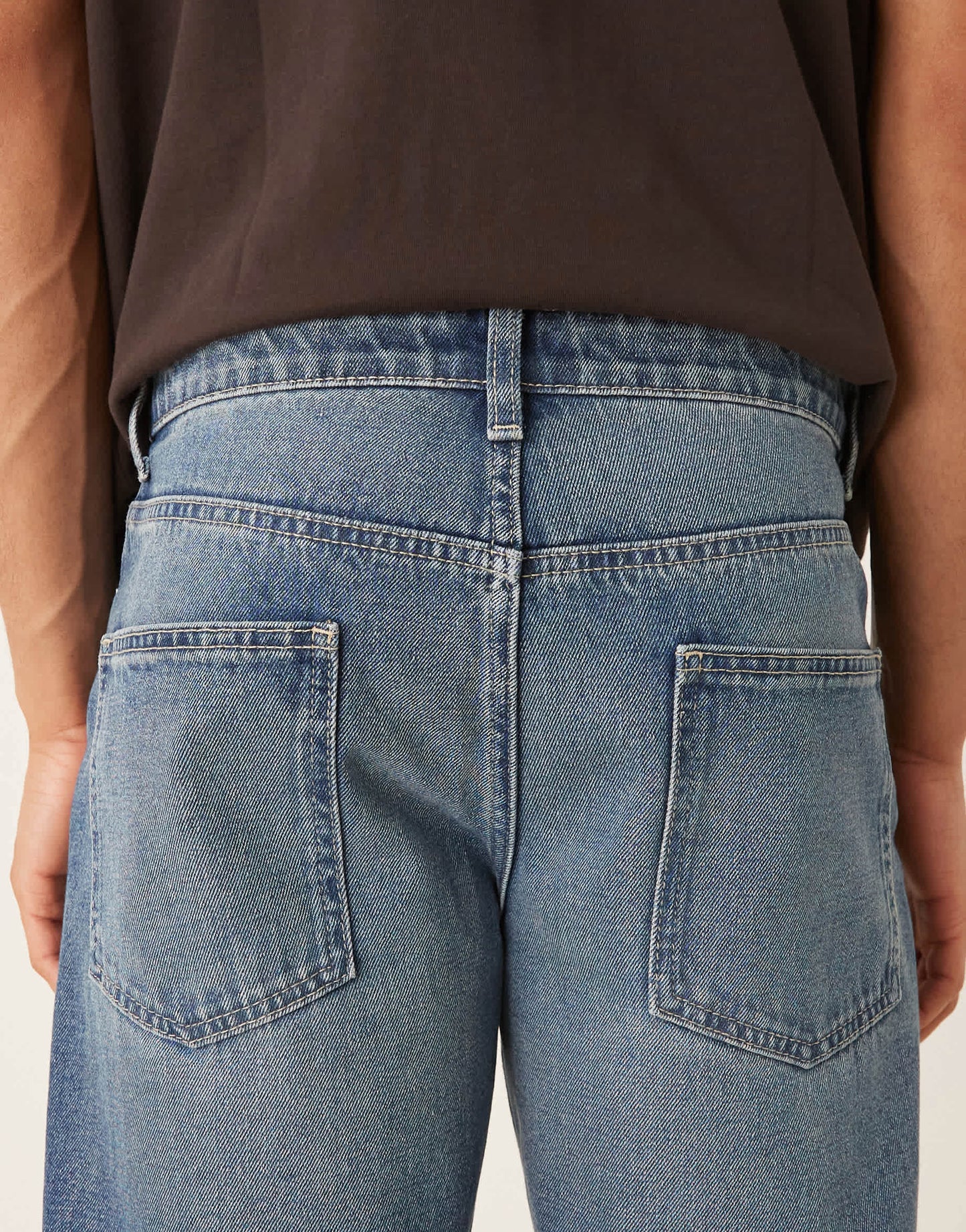 ASOS DESIGN tapered fit jeans with vintage tint in light wash blue