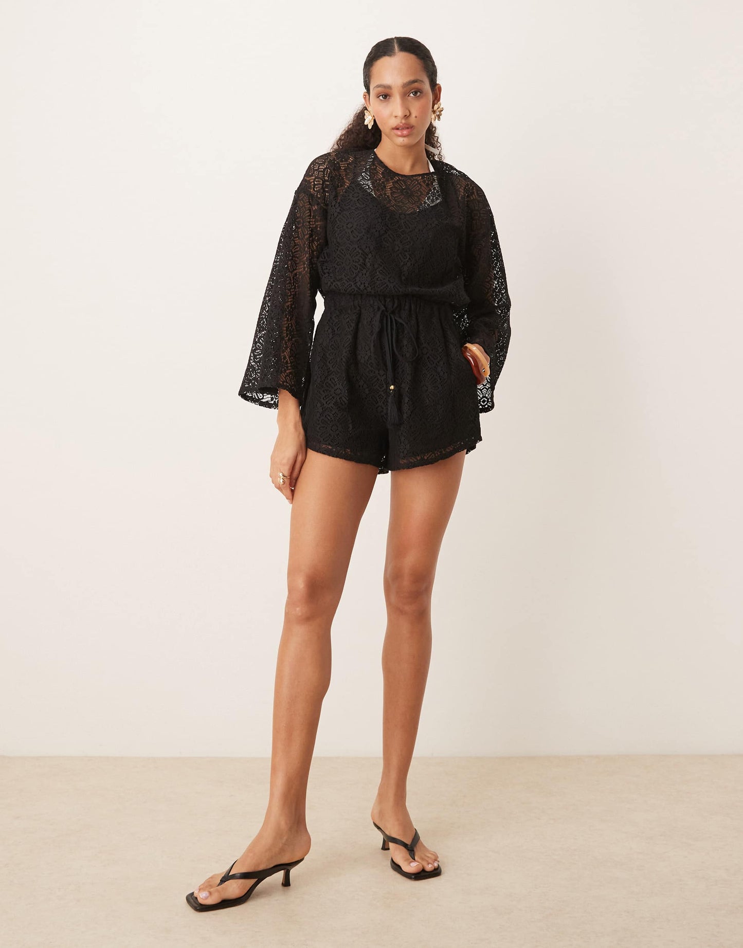 ASOS DESIGN crochet long sleeve mini playsuit with drawstring in black