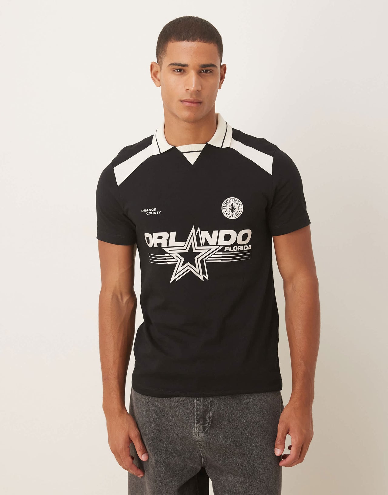 ASOS DESIGN polo with city graphic in black