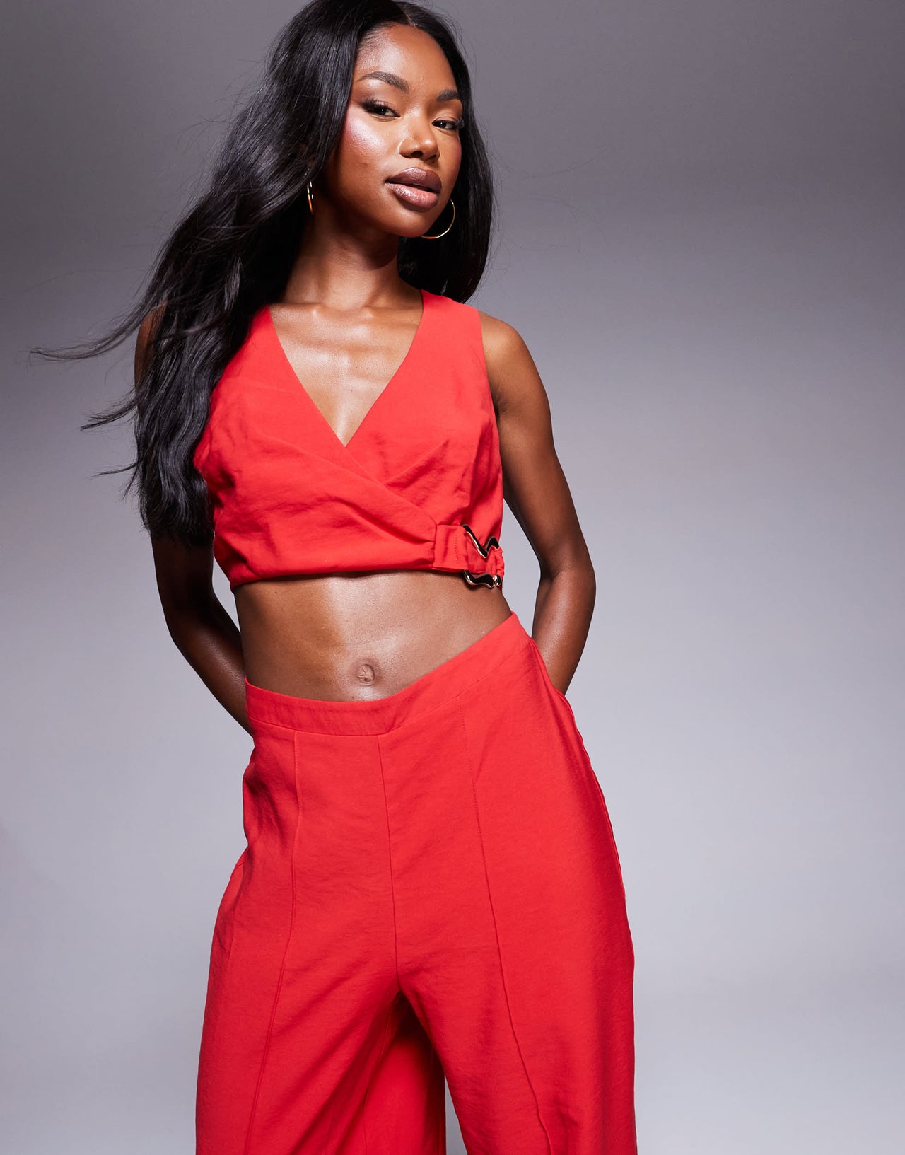 ASOS DESIGN wrap front cut out jumpsuit with buckle detail in red