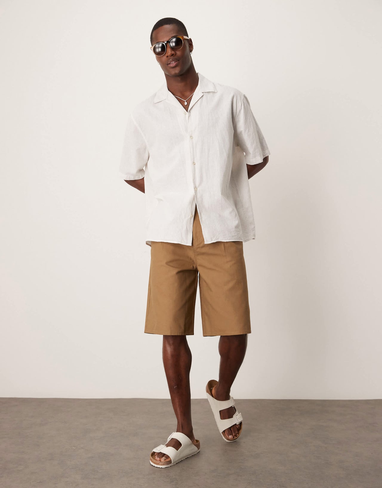 ASOS DESIGN long length pleated shorts in tan