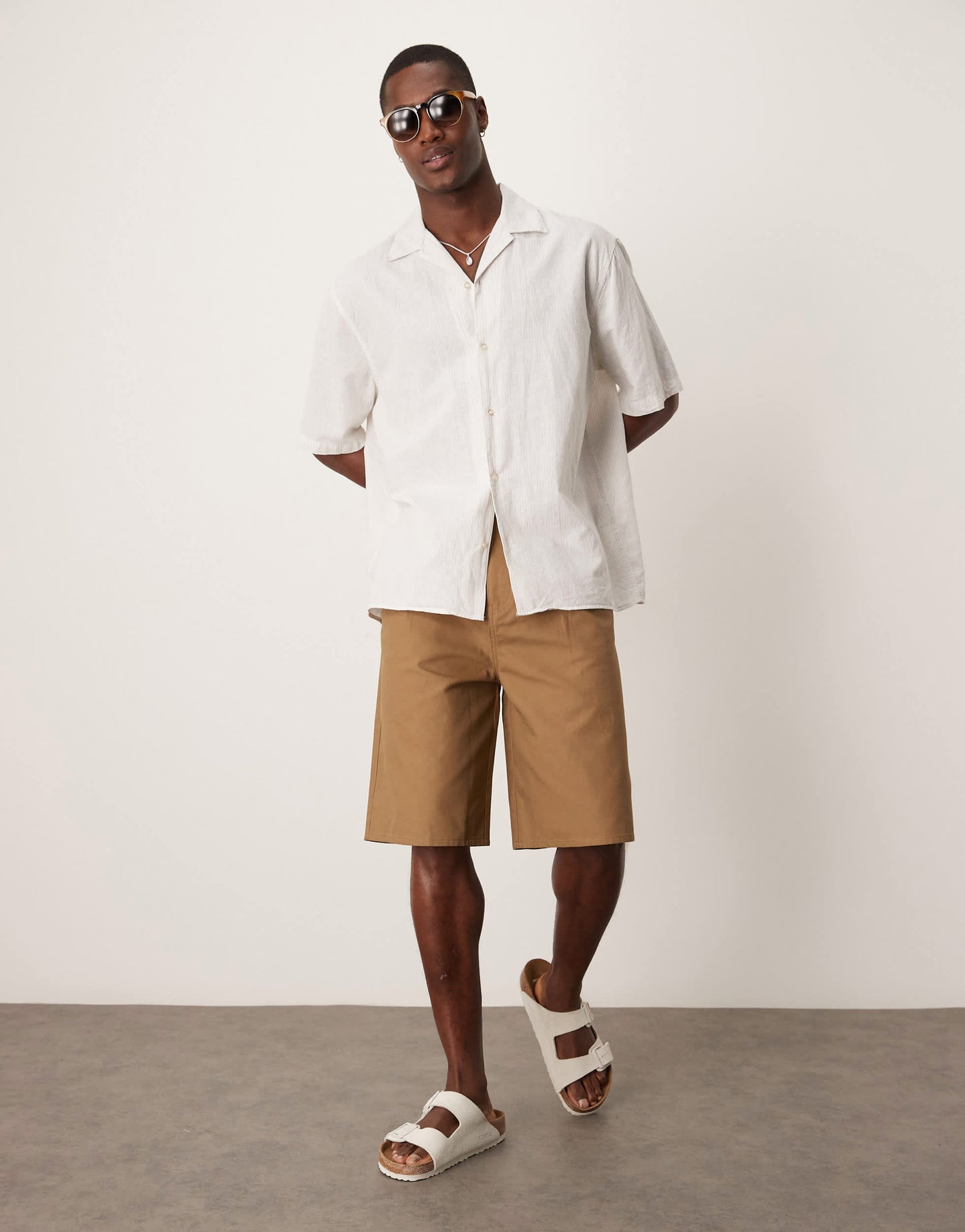 ASOS DESIGN long length pleated shorts in tan