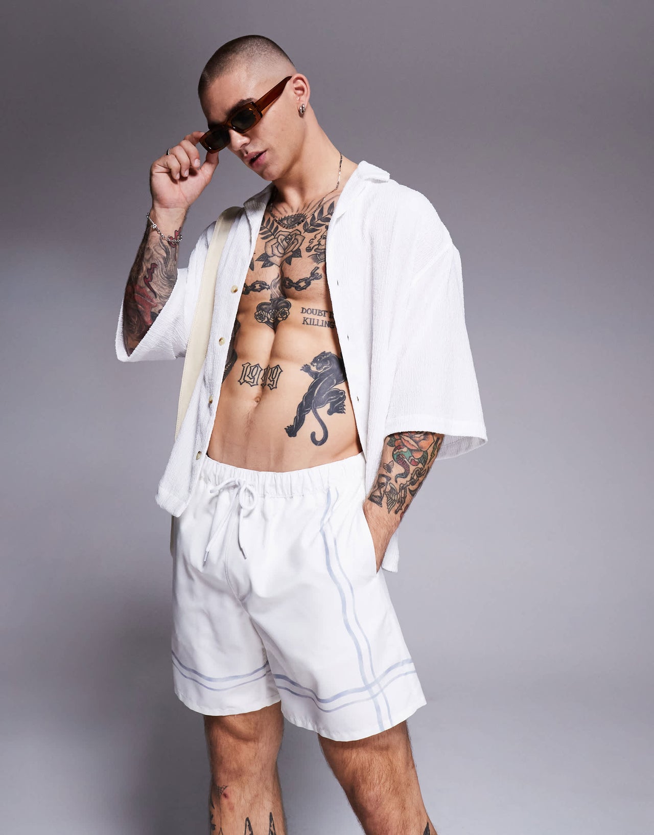 ASOS DESIGN swim shorts in mid length in stone with border print