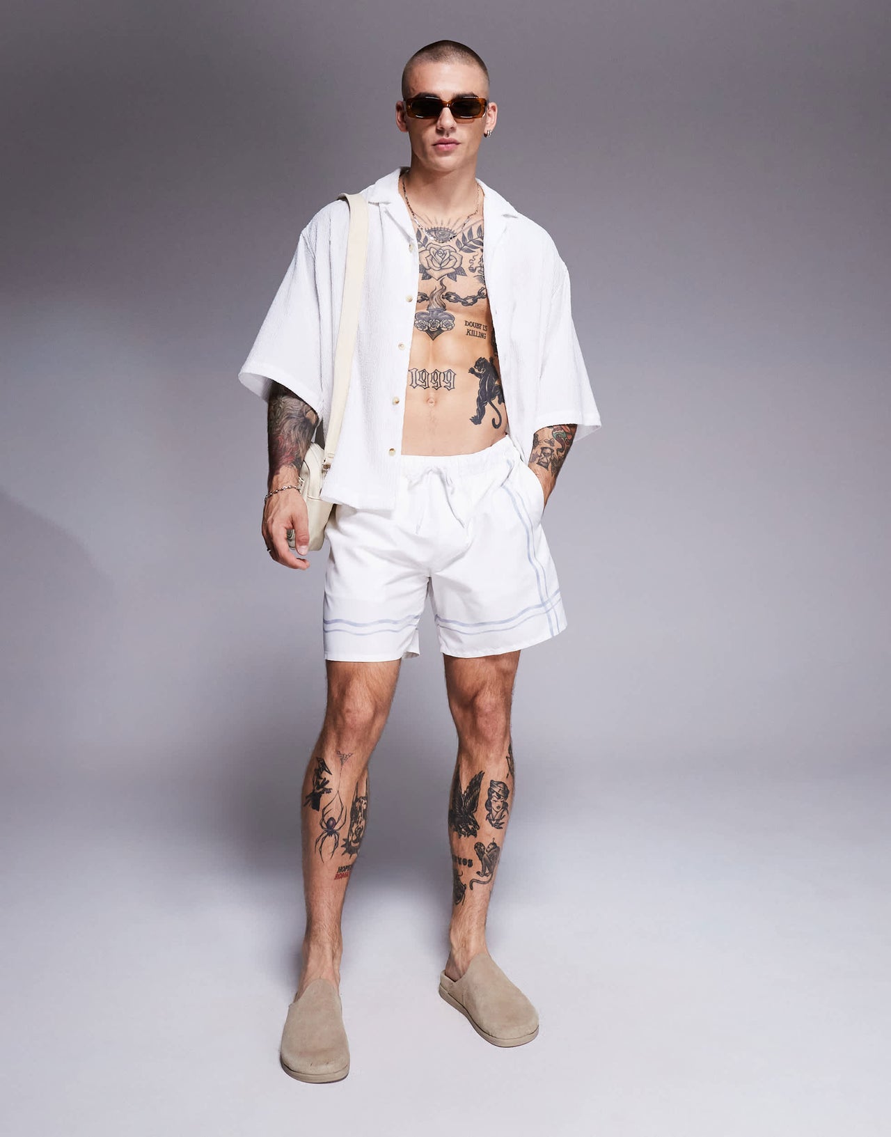 ASOS DESIGN swim shorts in mid length in stone with border print