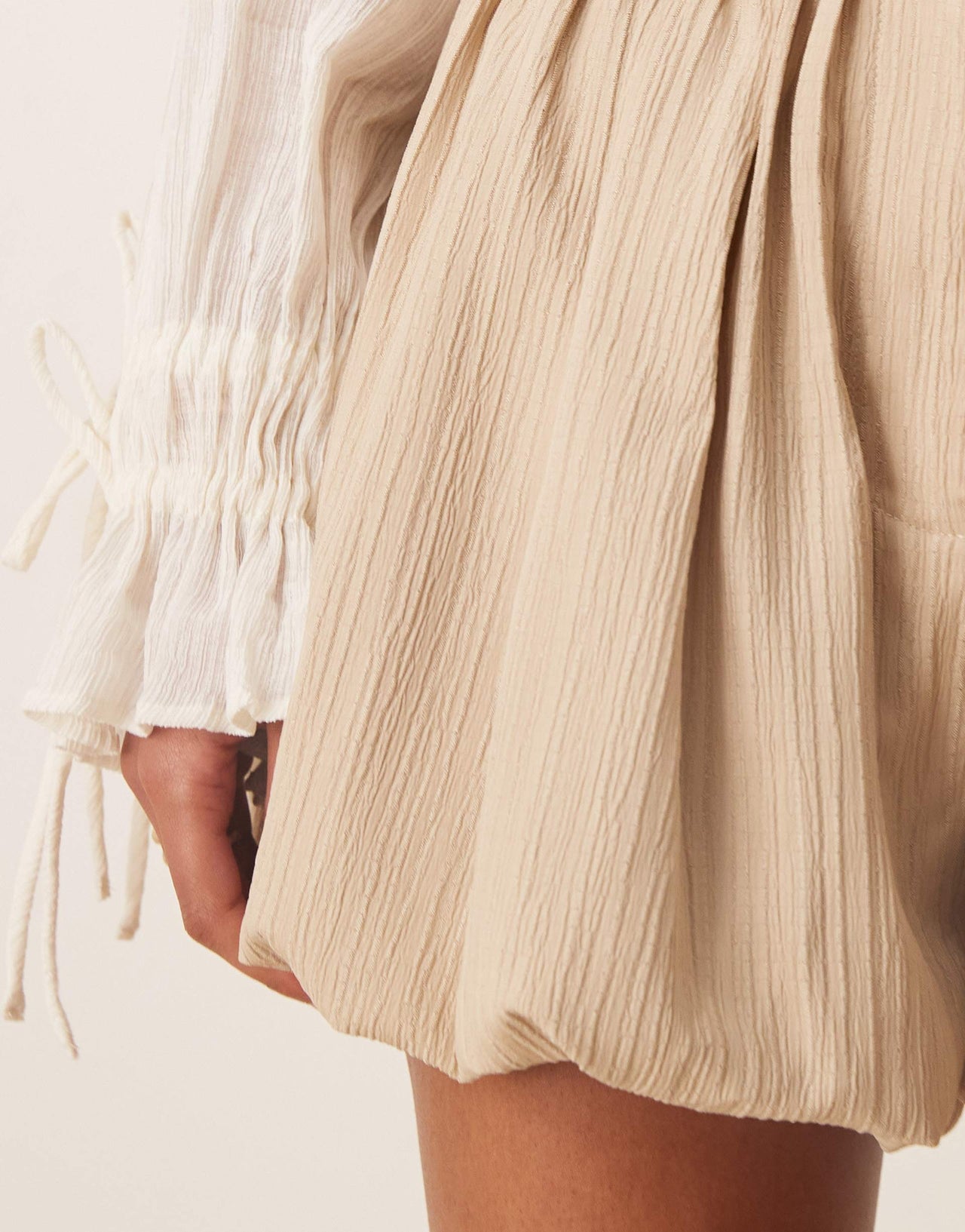 ASOS DESIGN tailored crinkle puffball hem shorts in stone