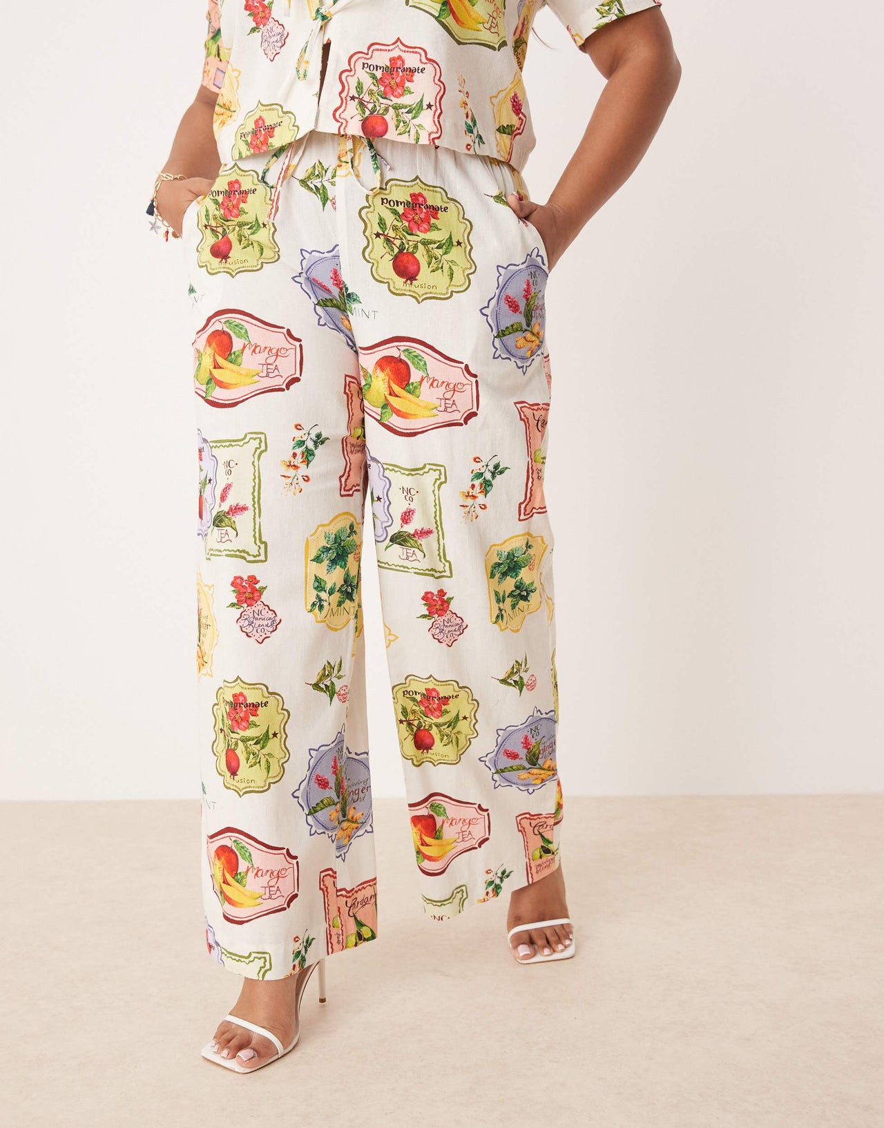 Nobody's Child Plus Shona straight leg trousers co-ord in postcard fruit print