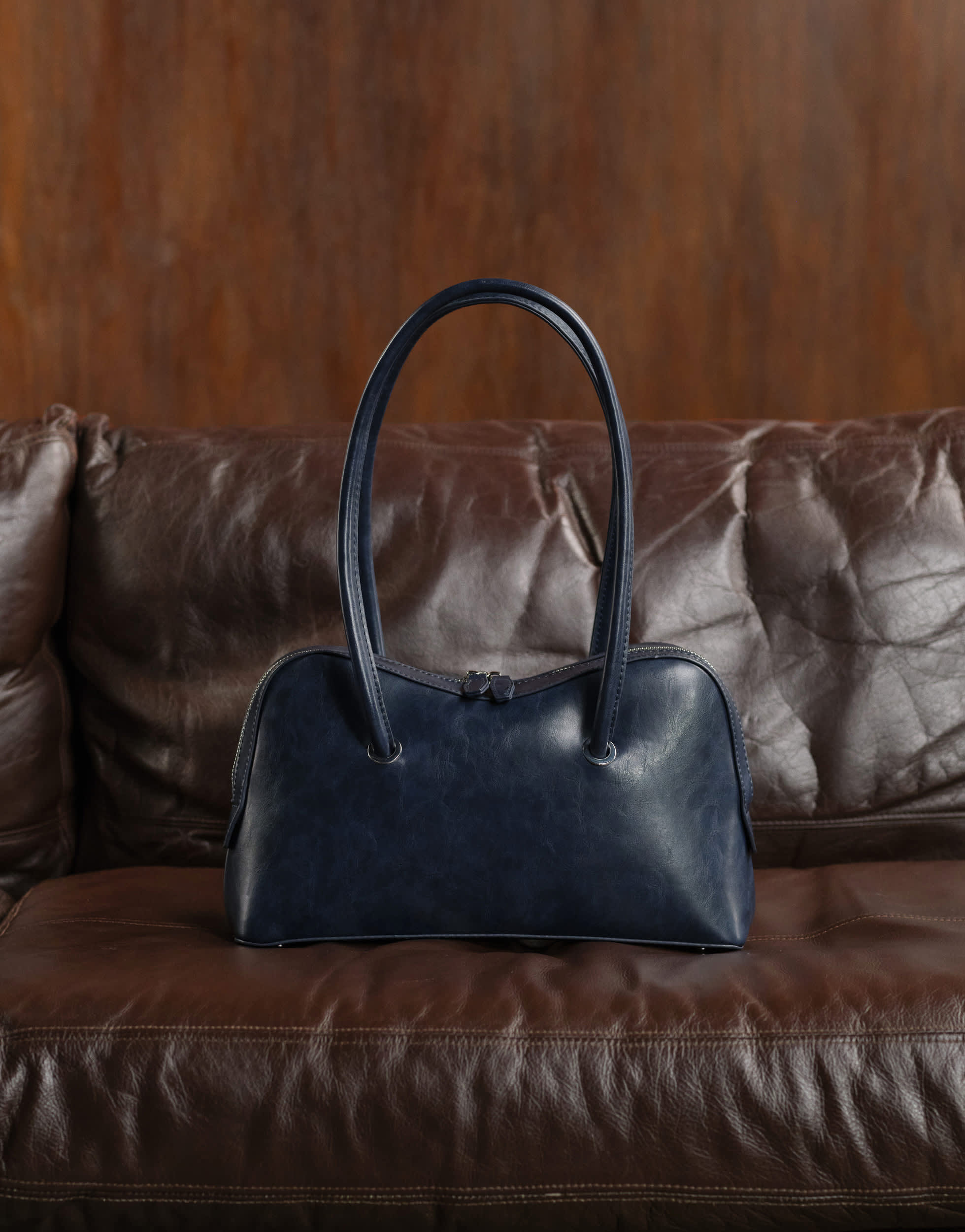 ASOS DESIGN bowler bag with curve detail in washed navy