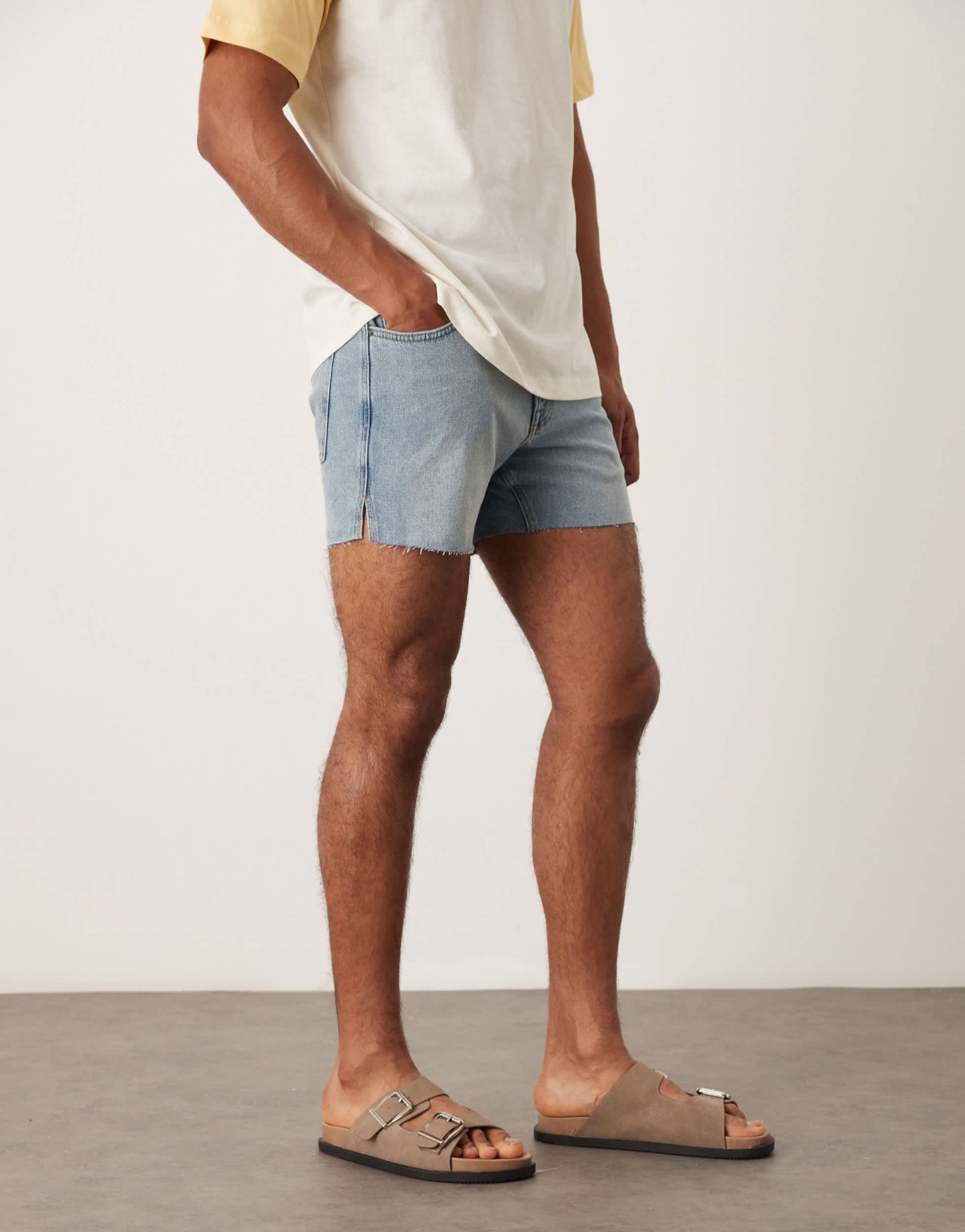 ASOS DESIGN shorter length slim denim shorts with rip detail in light wash blue