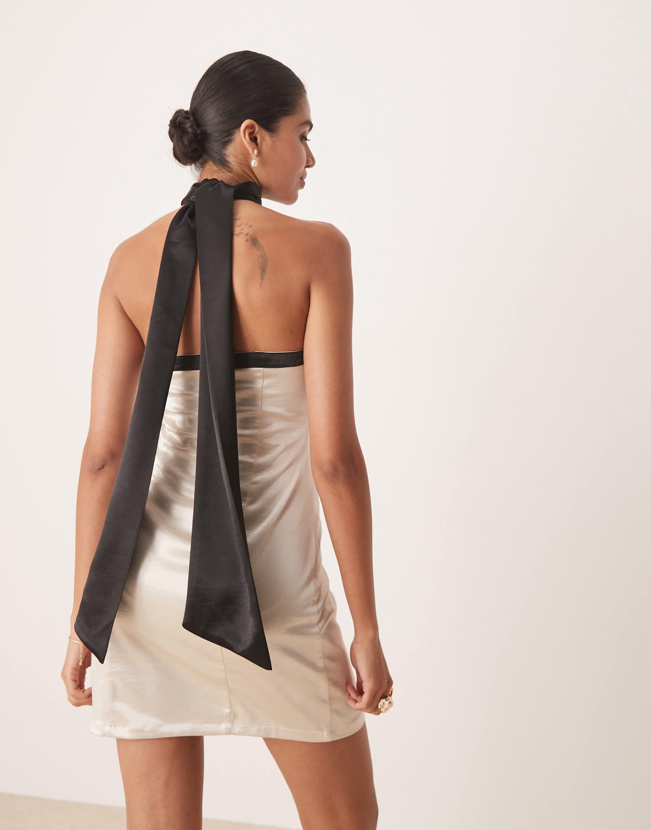Amy Lynn contrast halter neck satin mini dress in soft gold and black