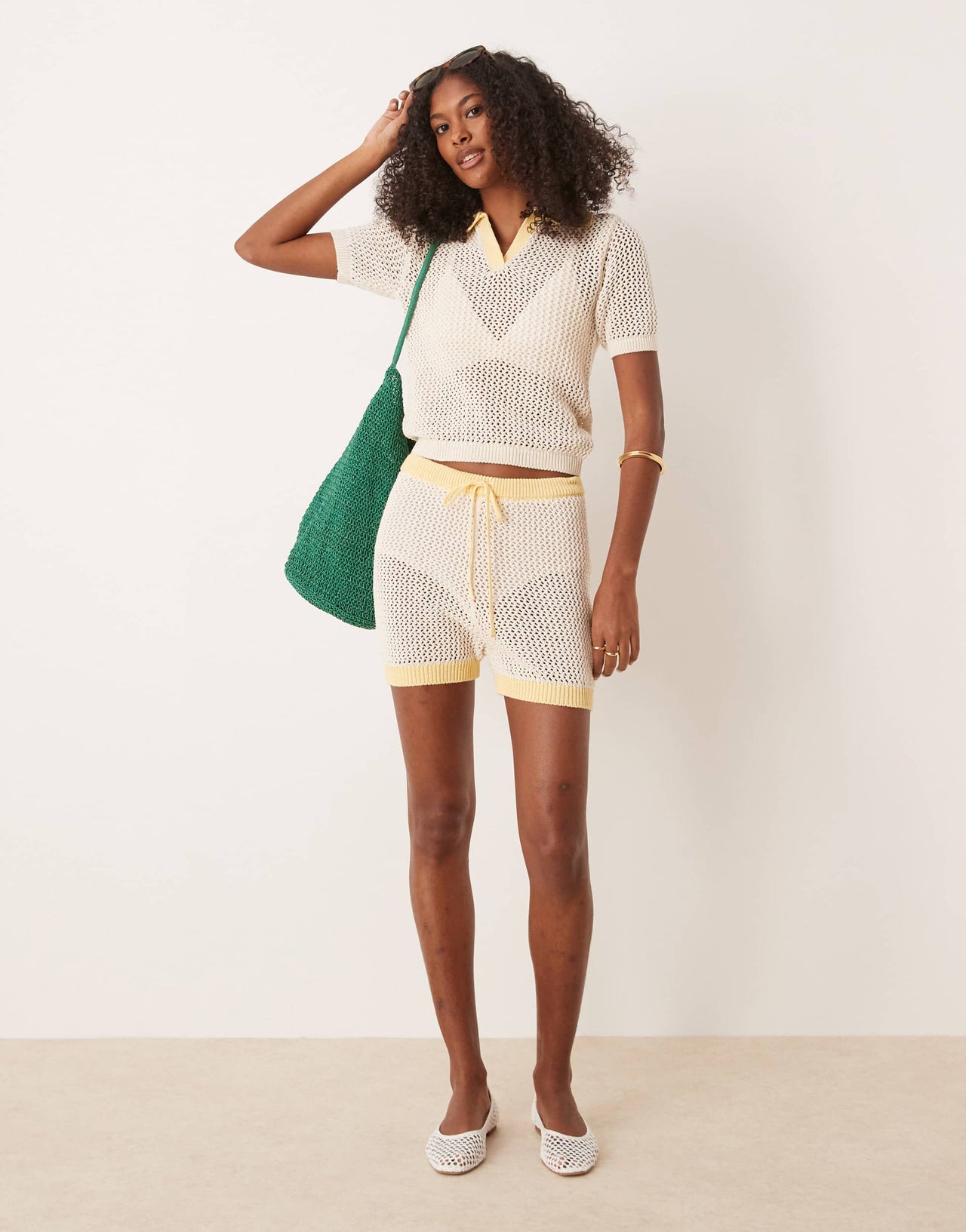 ASOS DESIGN co-ord knitted open stitch contrast trim shorts in cream and yellow
