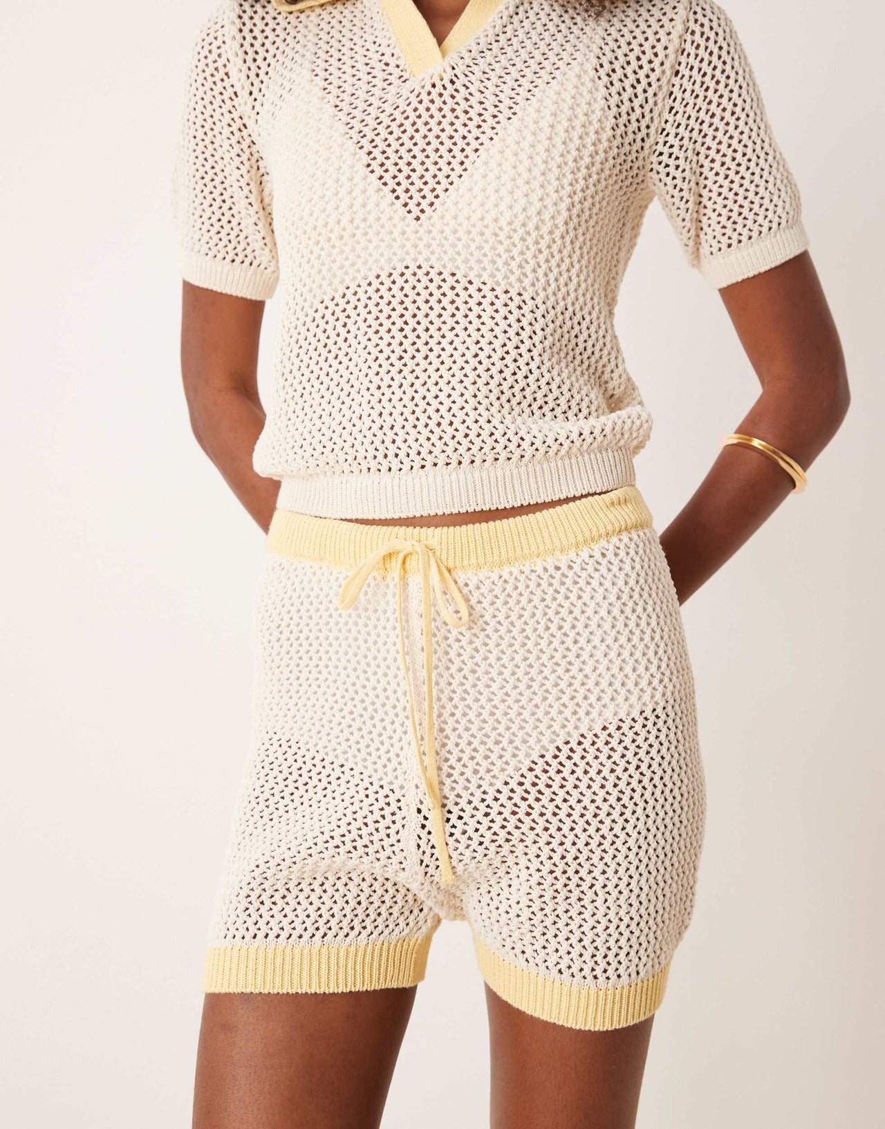 ASOS DESIGN co-ord knitted open stitch contrast trim shorts in cream and yellow