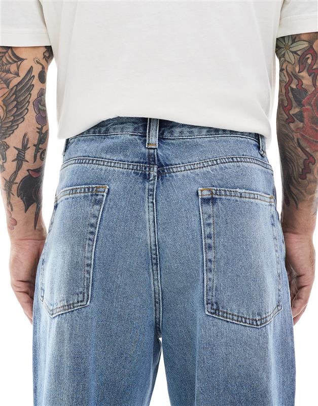 ASOS DESIGN loose jeans in midwash blue