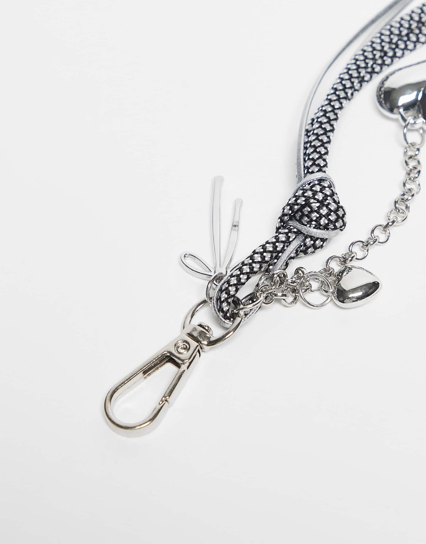 DesignB London bungee cord and heart bag charm in black and white polka dot