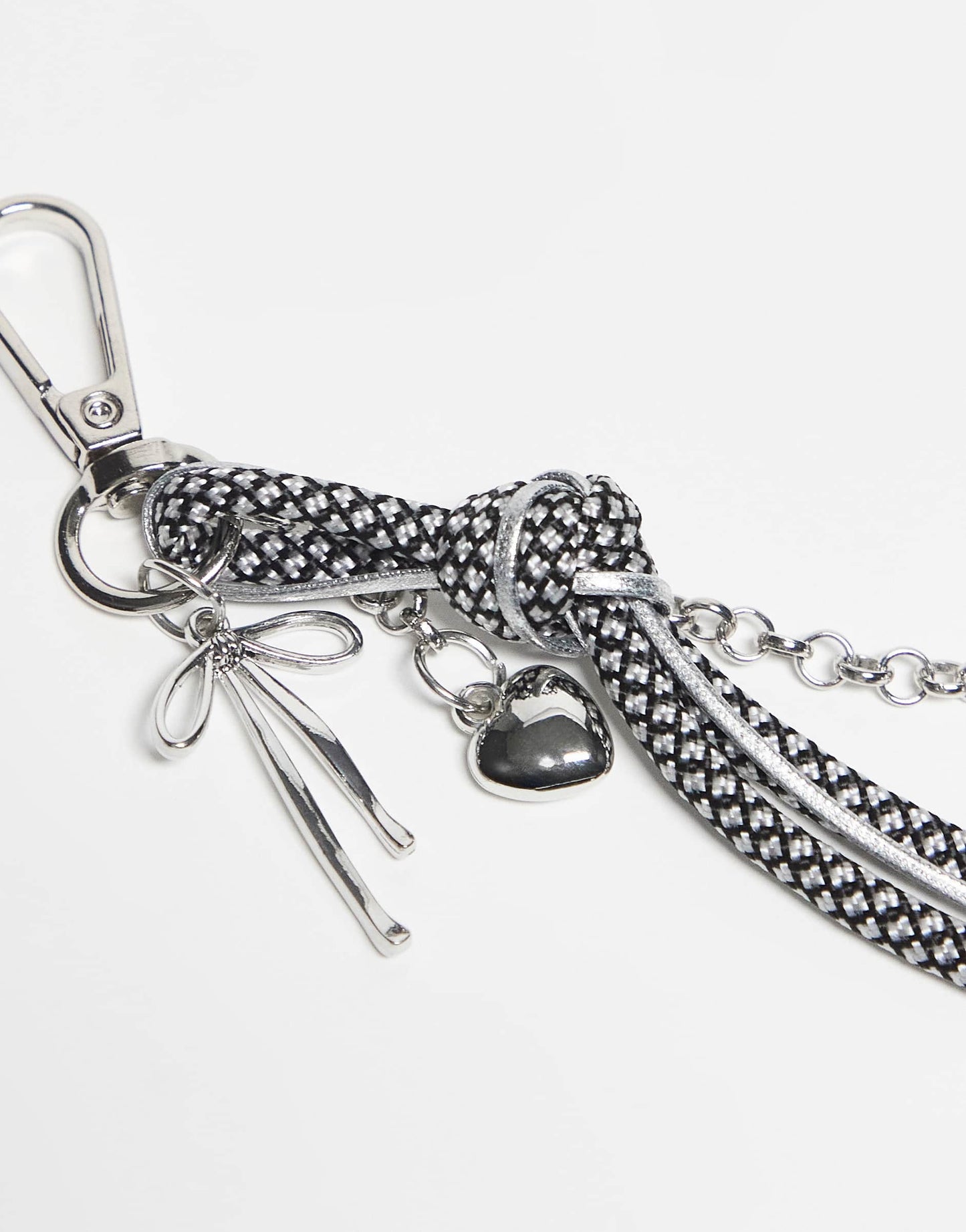DesignB London bungee cord and heart bag charm in black and white polka dot