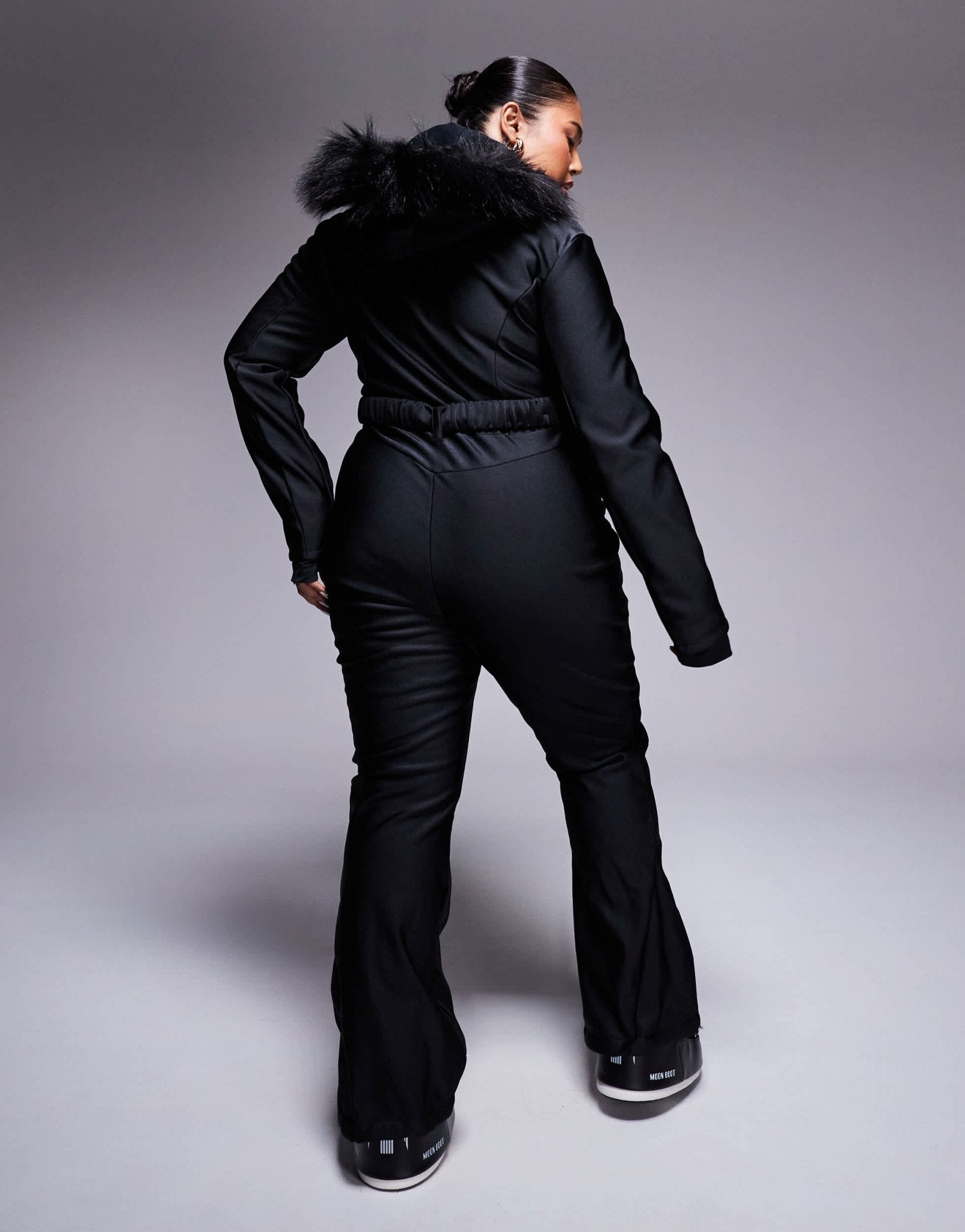 4505 Curve Ski belted ski suit with slim kick leg and faux fur hood in black gloss - ASOS Sample Sale