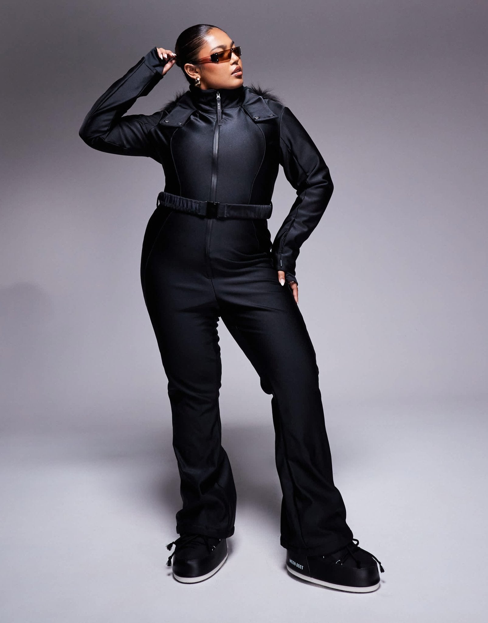 4505 Curve Ski belted ski suit with slim kick leg and faux fur hood in black gloss - ASOS Sample Sale