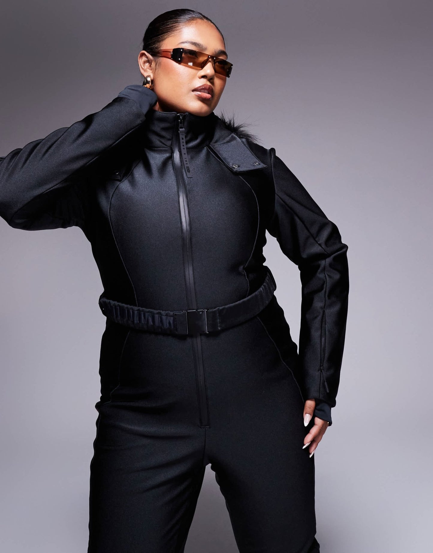 4505 Curve Ski belted ski suit with slim kick leg and faux fur hood in black gloss - ASOS Sample Sale