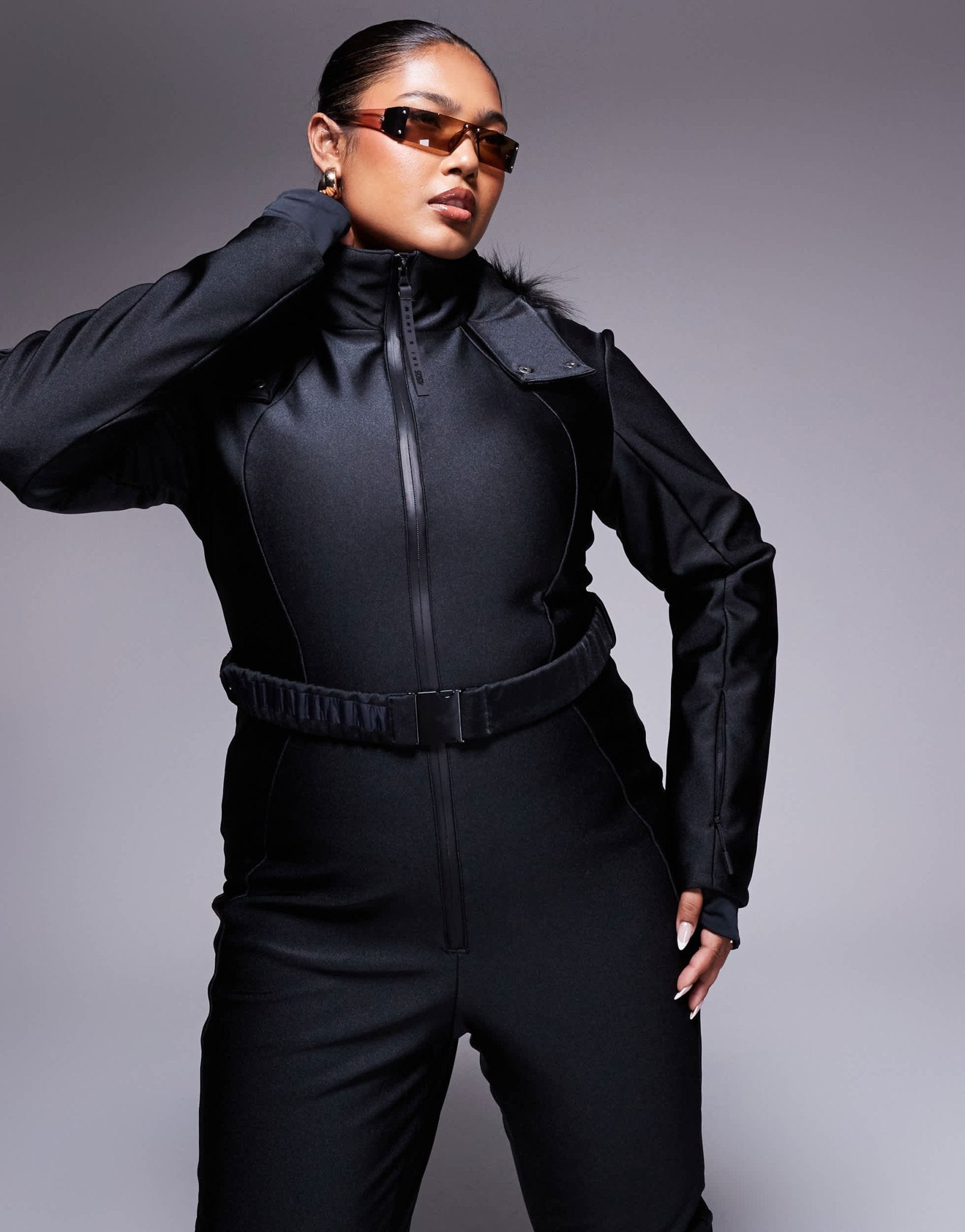 4505 Curve Ski belted ski suit with slim kick leg and faux fur hood in black gloss - ASOS Sample Sale