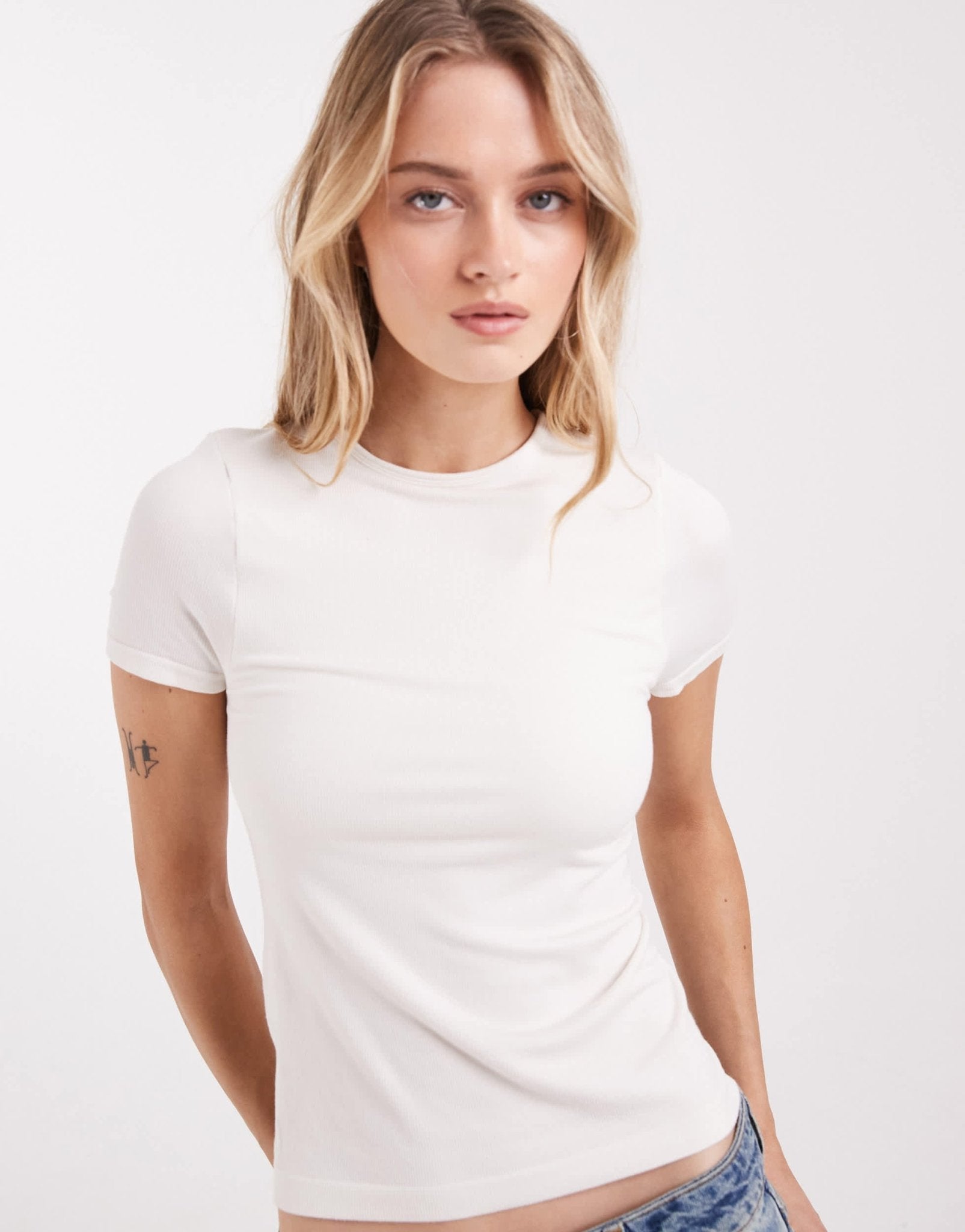 ASOS DESIGN bra free seamless rib crew neck baby tee in cream - ASOS Sample Sale