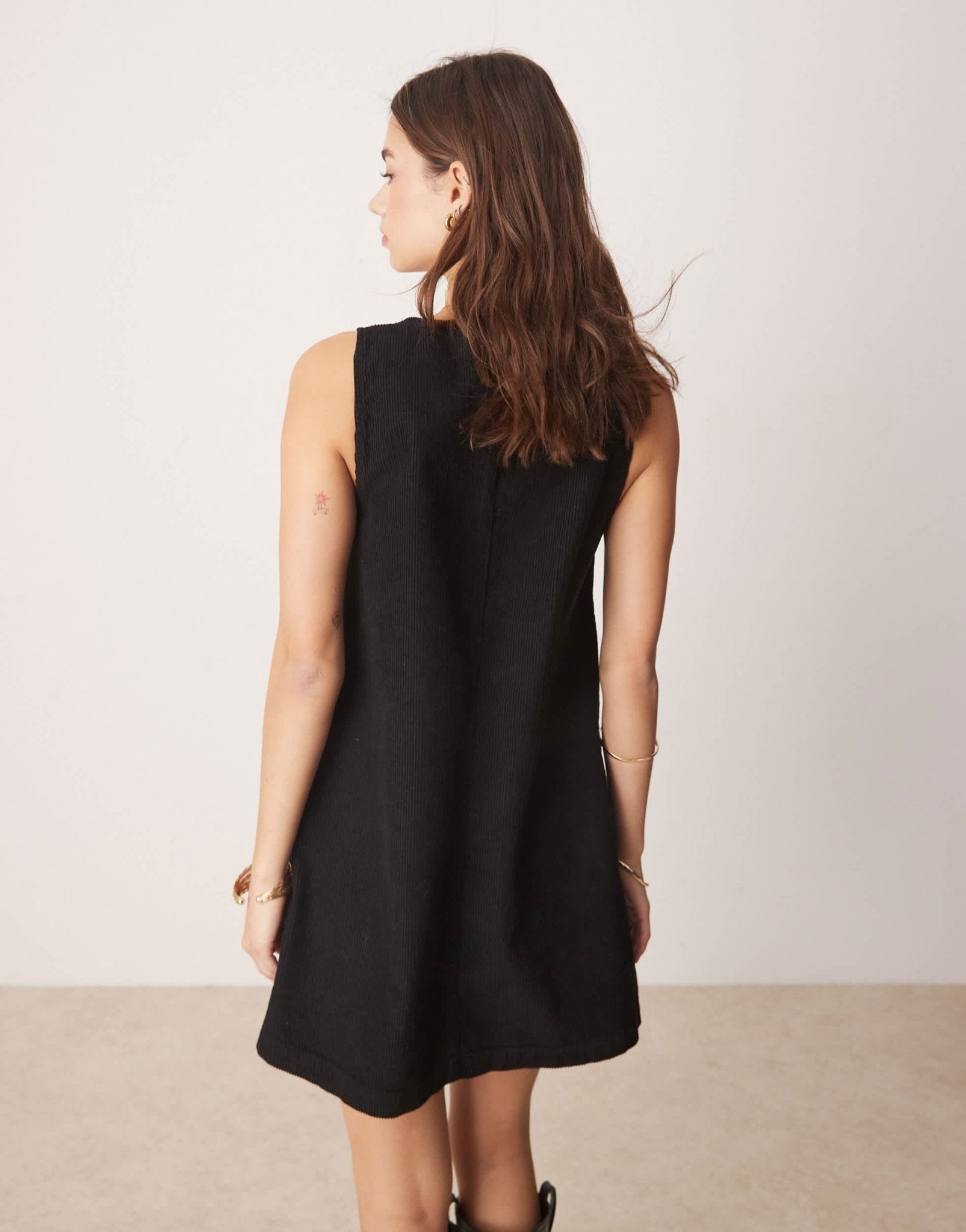ASOS DESIGN corduroy pinafore mini dress with oversized pockets in black - ASOS Sample Sale
