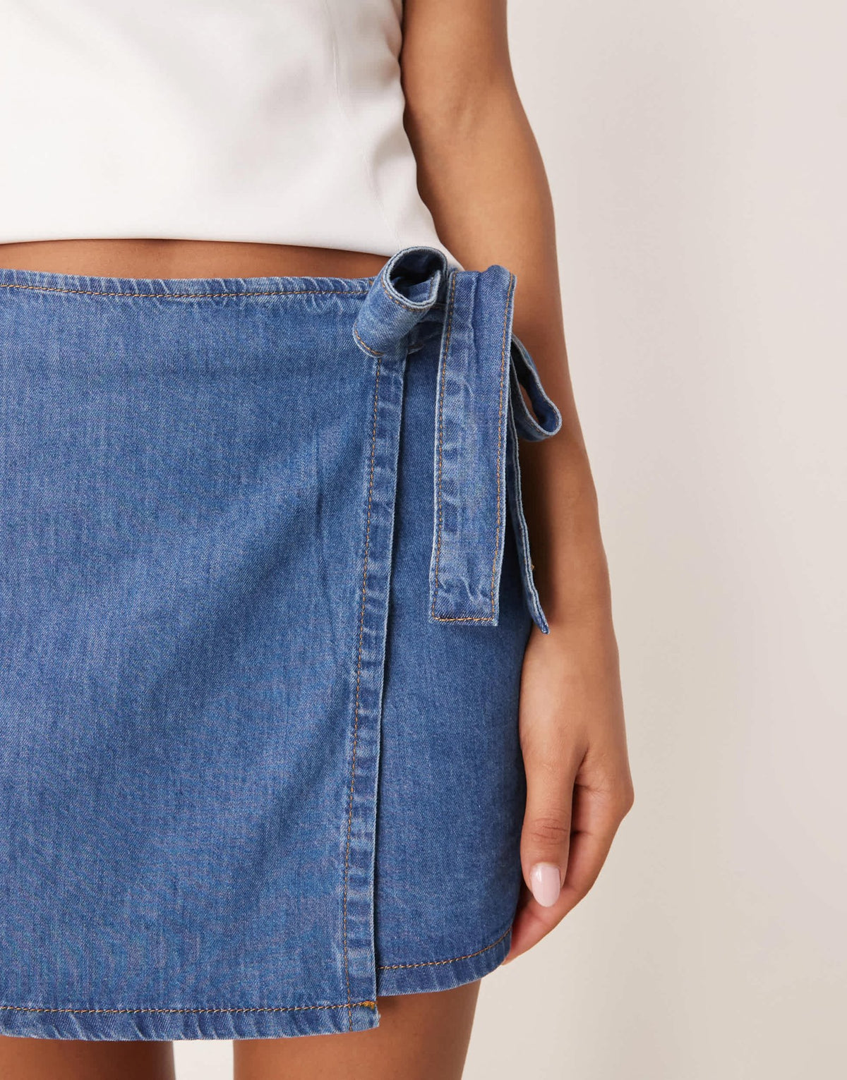 ASOS DESIGN denim wrap front mini skirt with bow detail in mid blue - ASOS Sample Sale