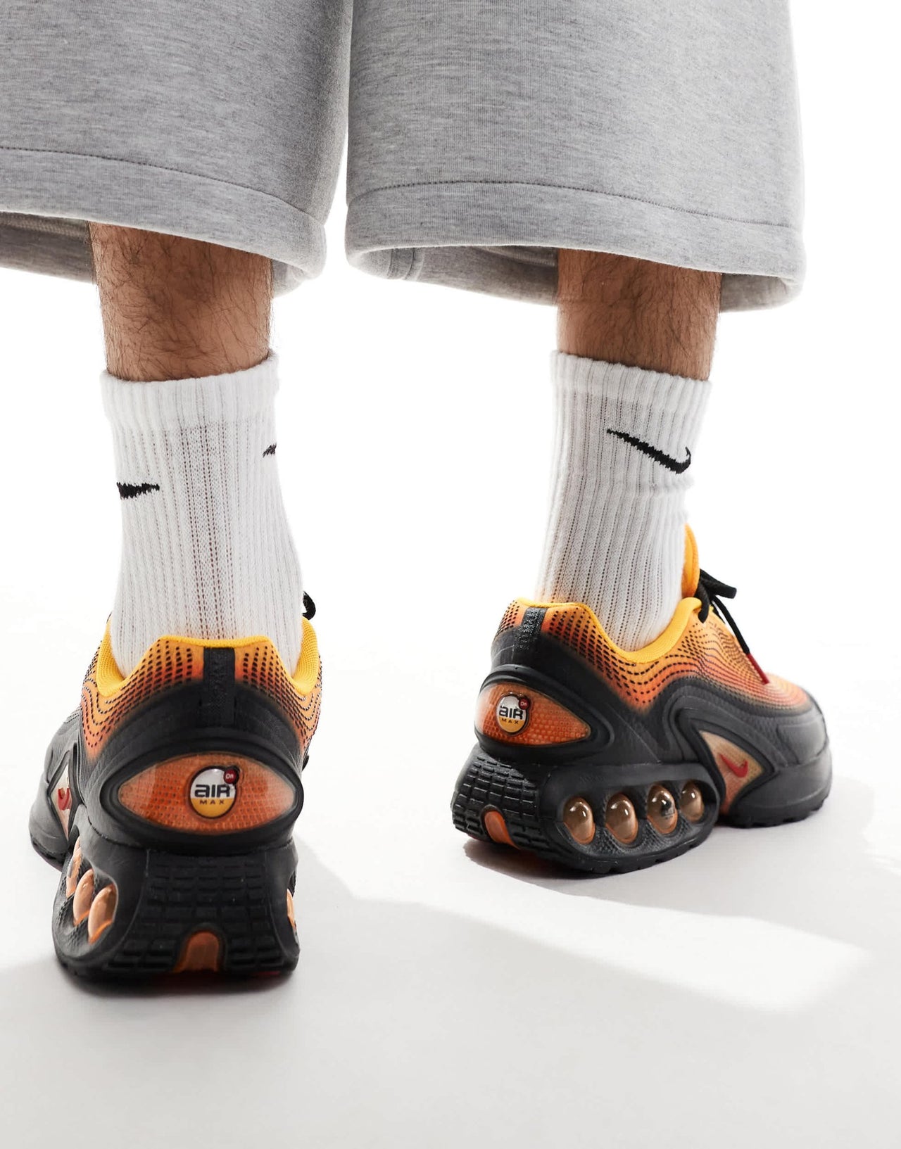 Nike Air Max DN trainers in black and orange - ASOS Sample Sale
