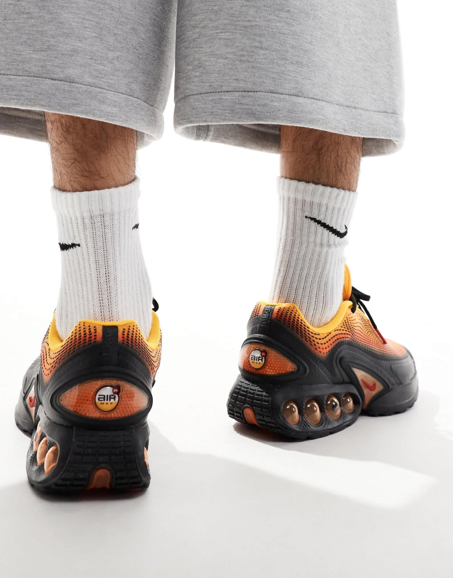 Nike Air Max DN trainers in black and orange - ASOS Sample Sale