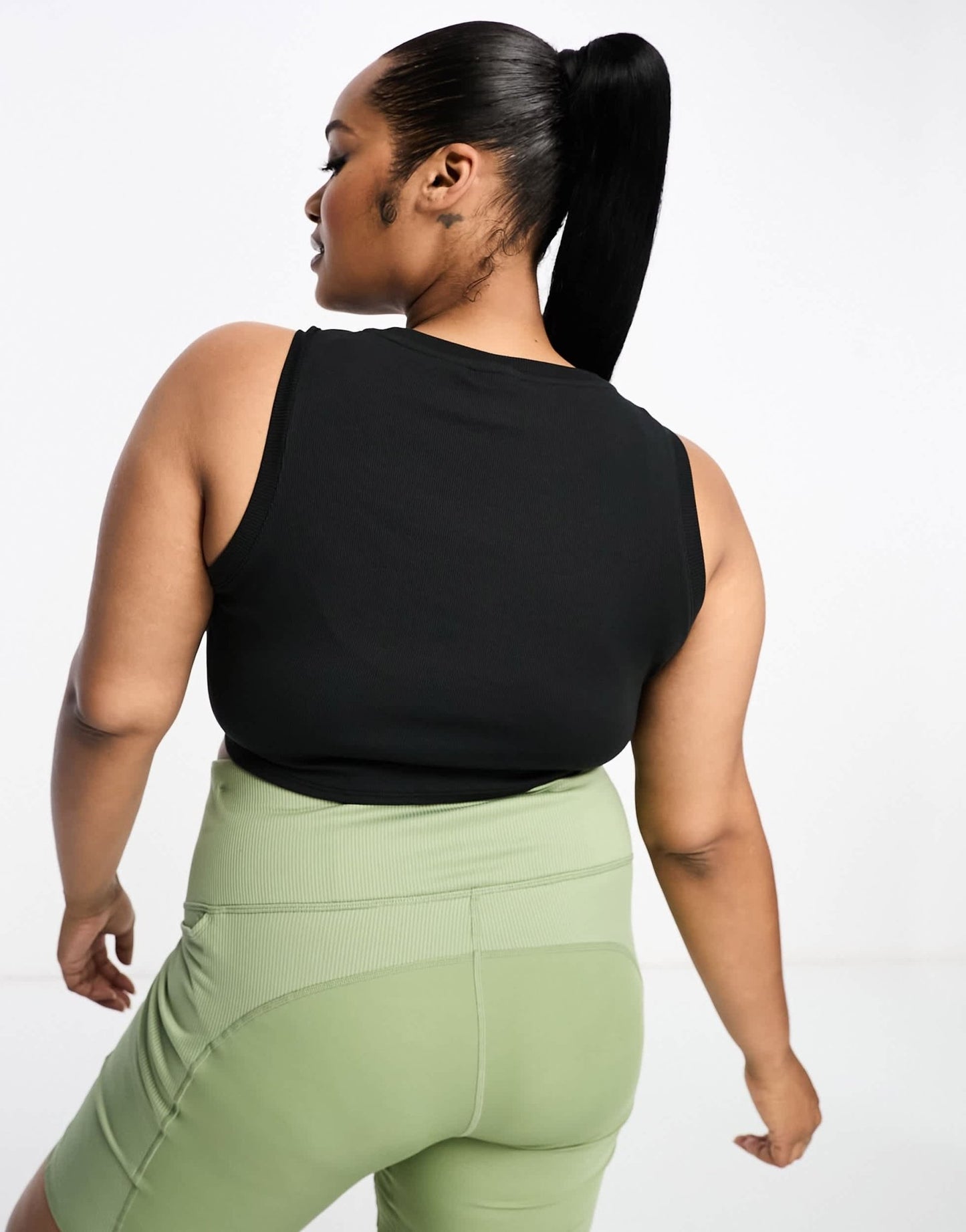 Nike Plus mini swoosh curve hem tank vest top in black - ASOS Sample Sale