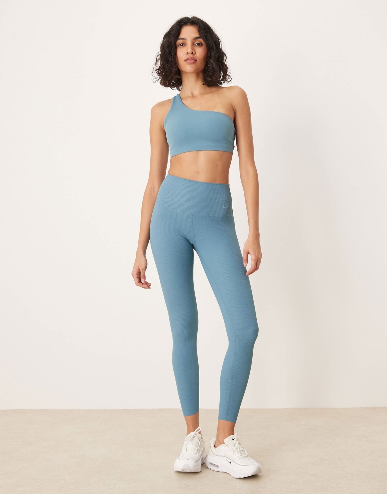 Nike Training Zenvy Dri-FIT soft touch asymmetric sports bra in blue - ASOS Sample Sale